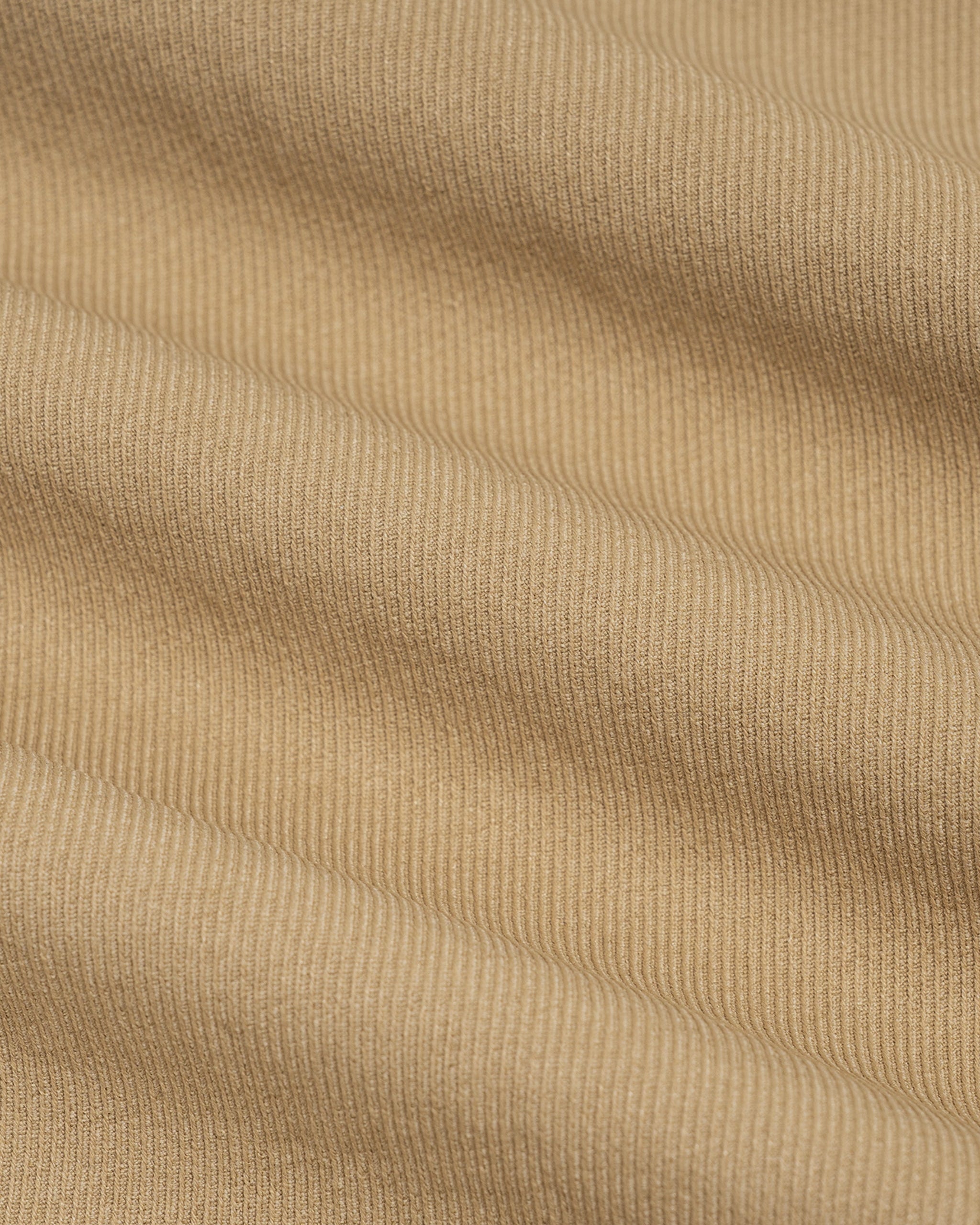 Close-up of beige fabric with a ribbed texture