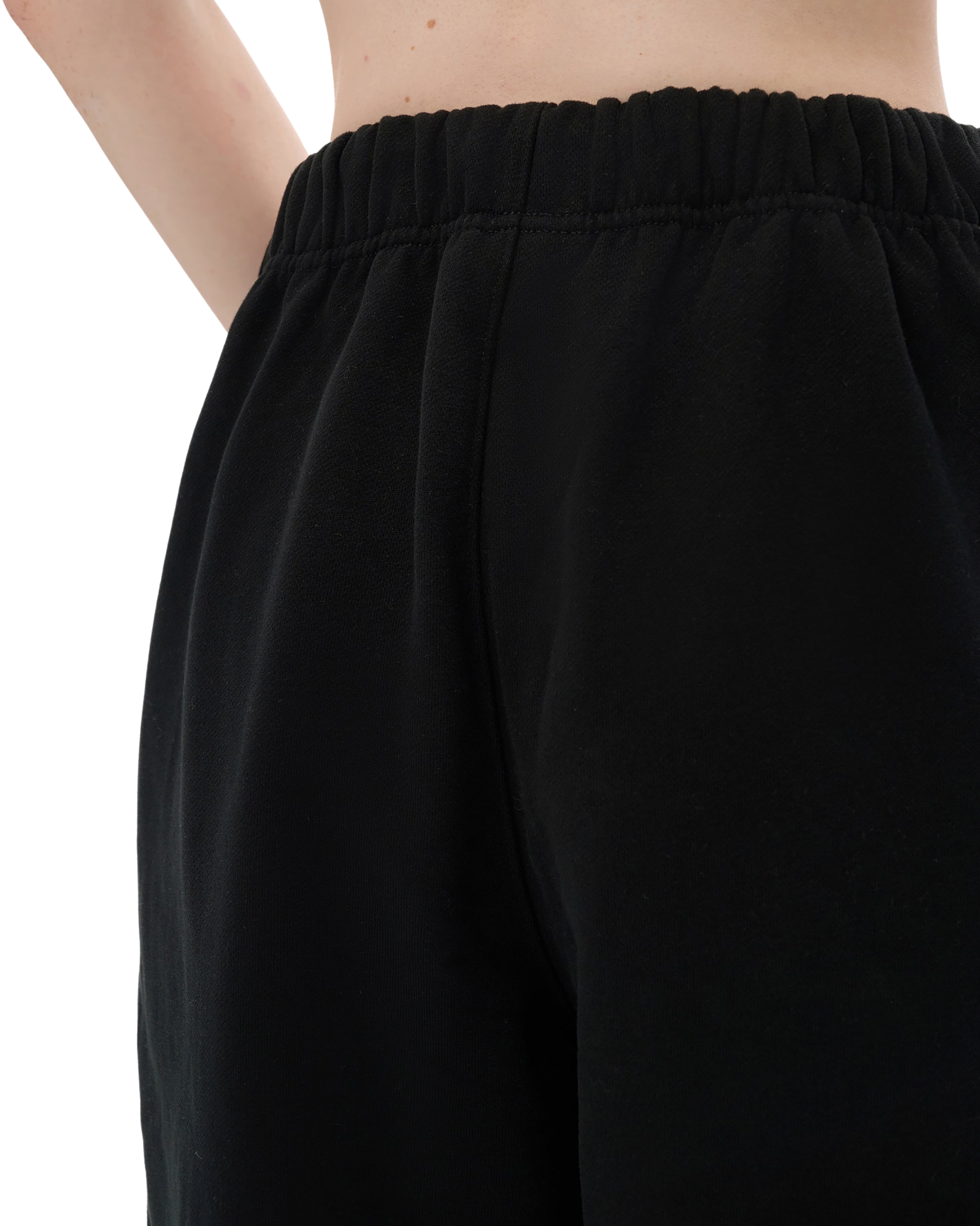 Black pants worn by a person on a white background