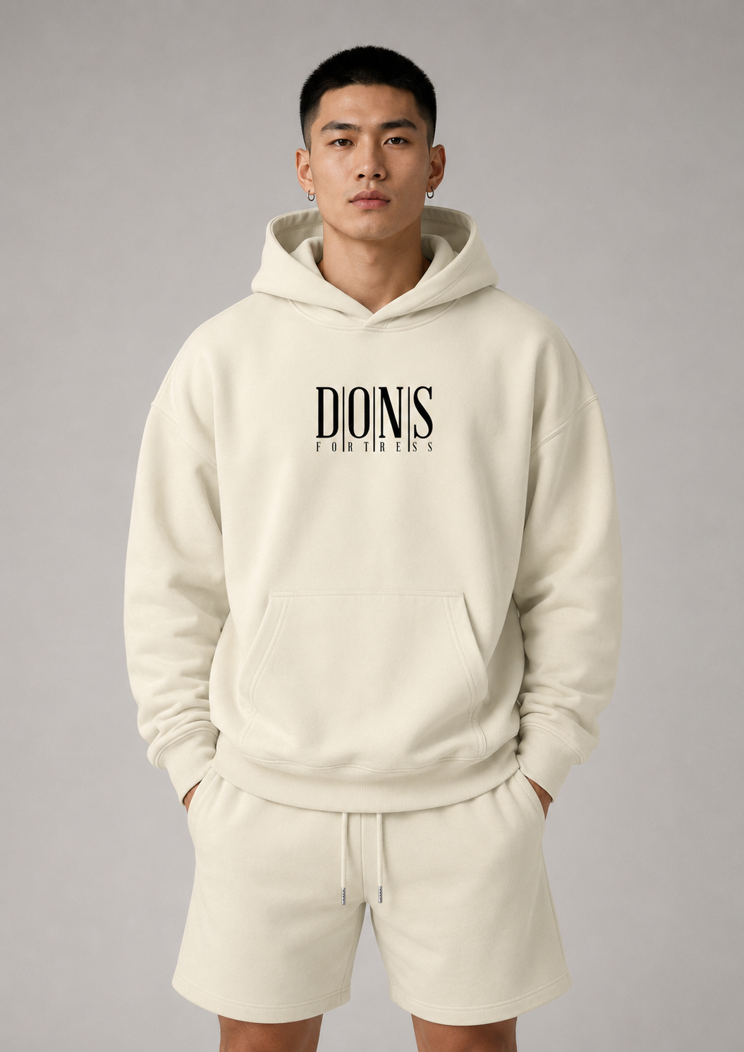 Person wearing a beige hoodie with 'Dionis' branding on a gray background