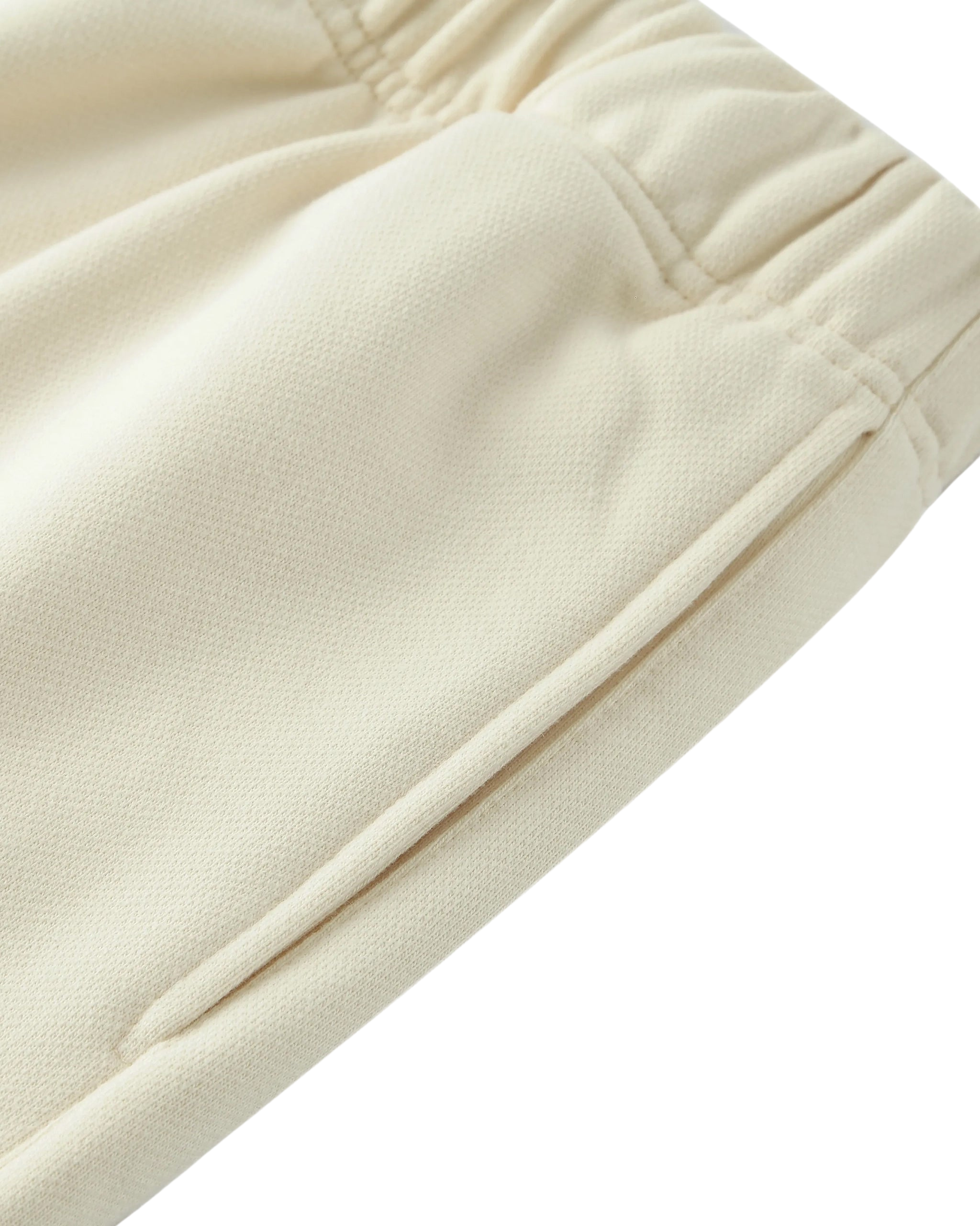 Close-up of beige fabric with a subtle texture on a white background