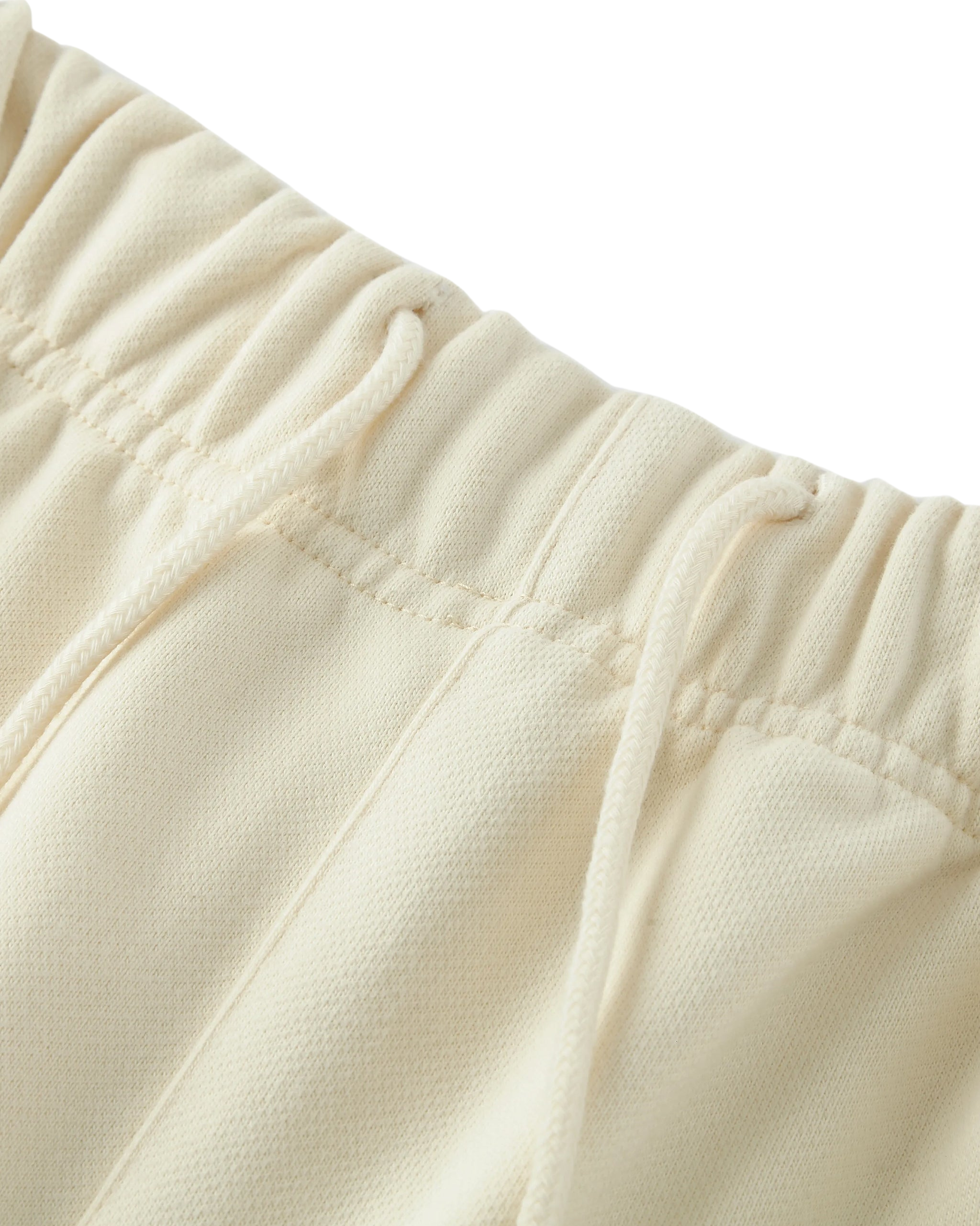 Close-up of beige fleece fabric with a focus on texture and stitching.