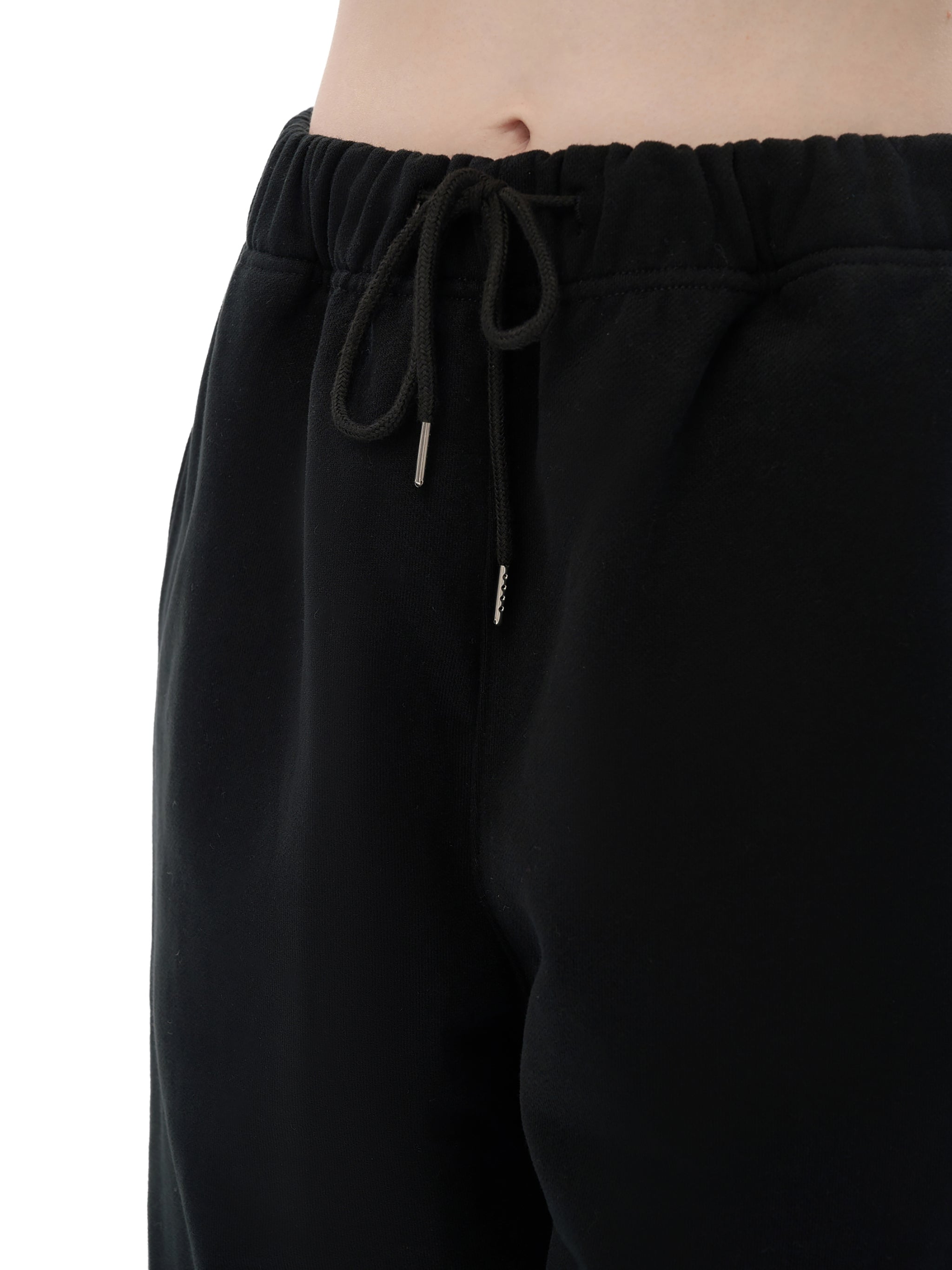 Black drawstring pants on a white background