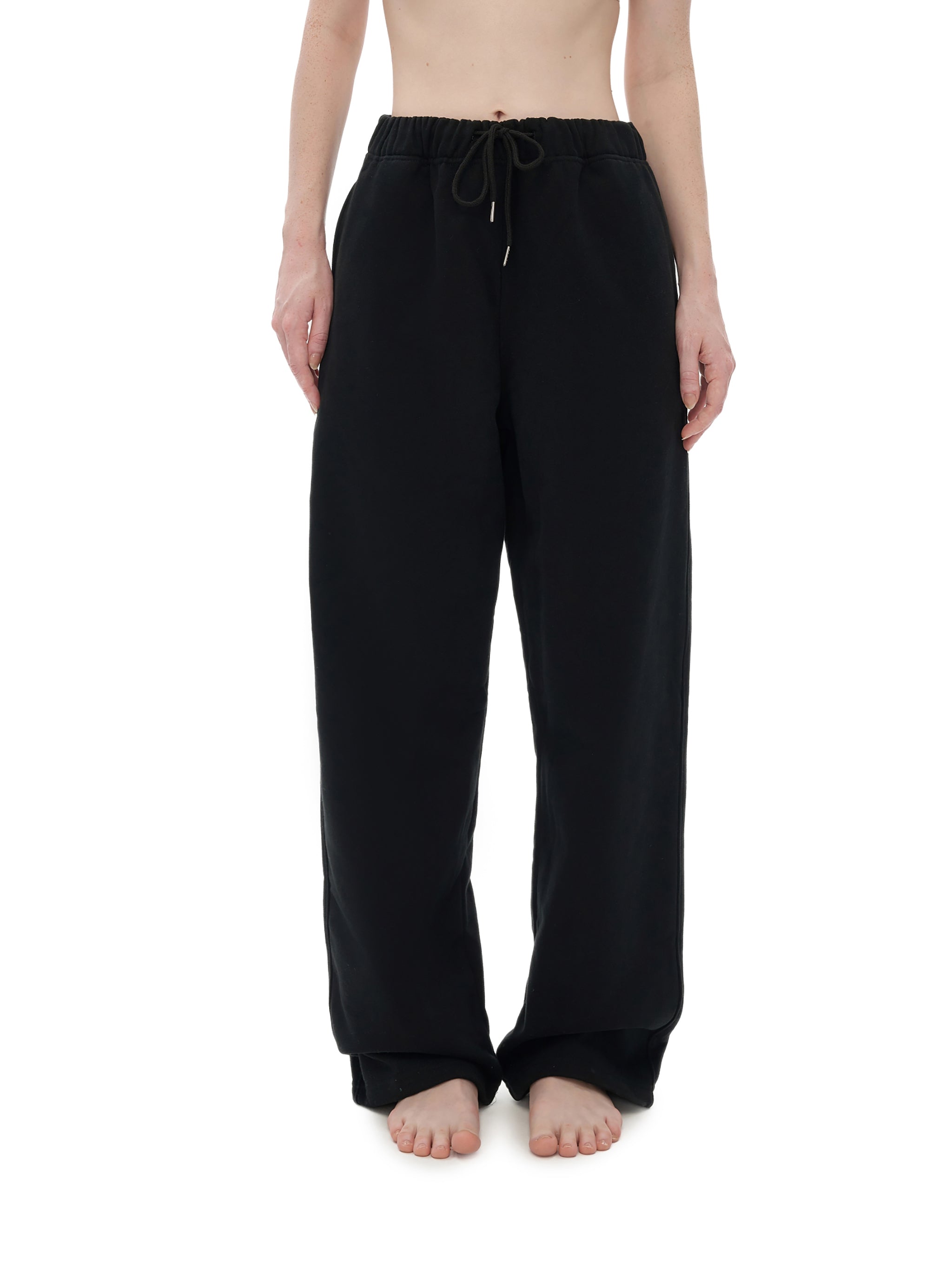 Person wearing black pants on a white background