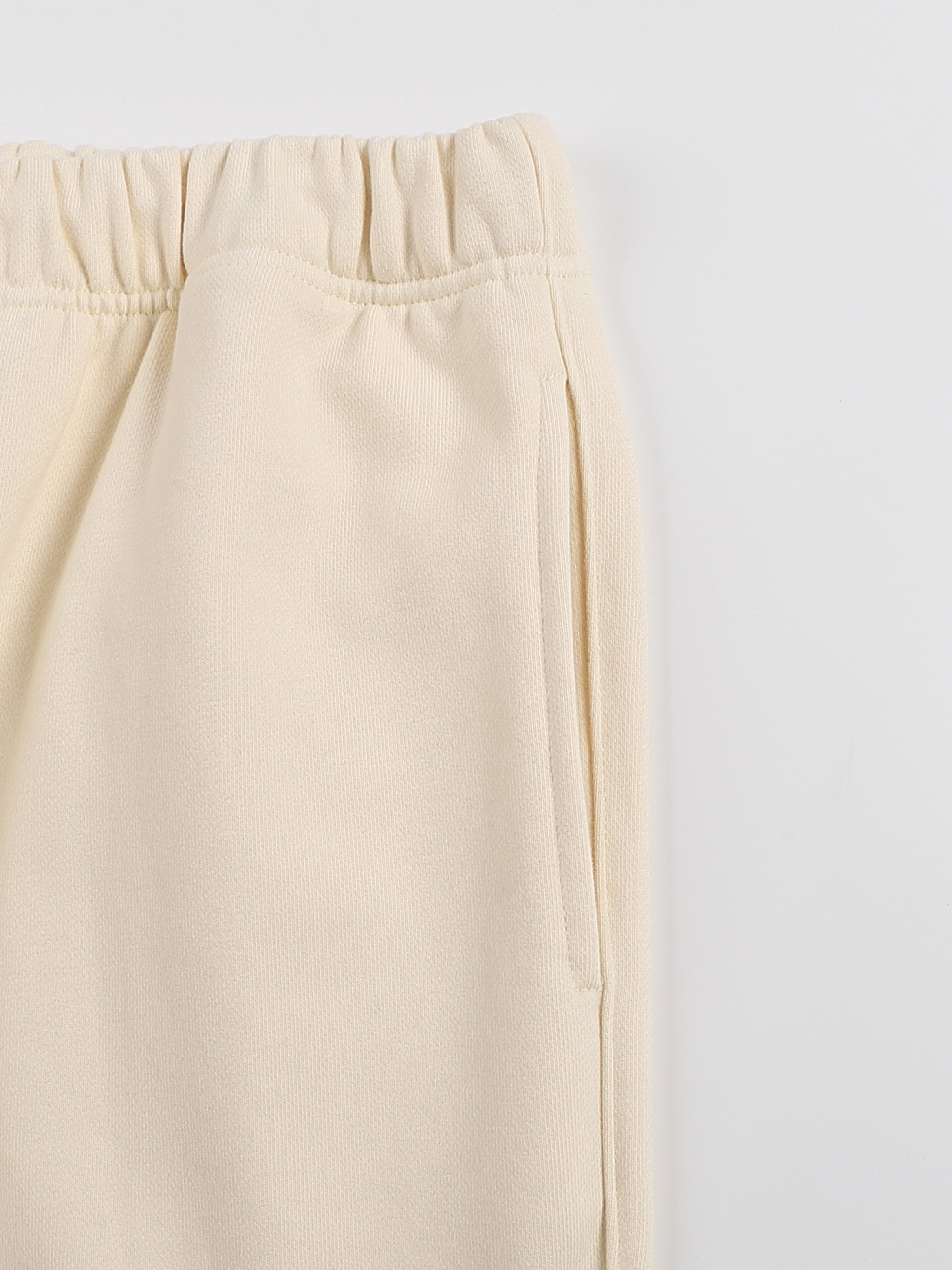 Beige pants on a light gray background