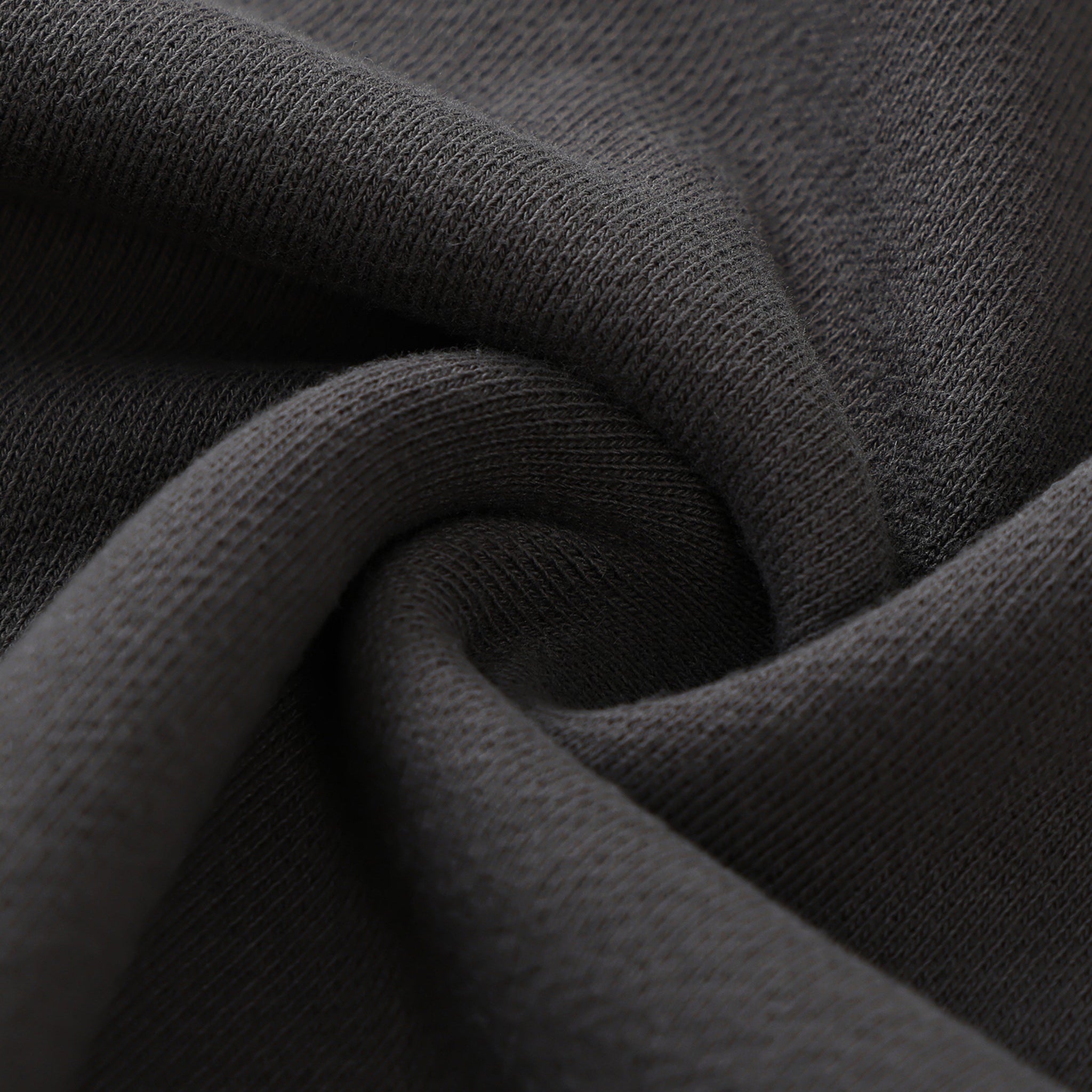 Close-up of dark gray fabric with folds