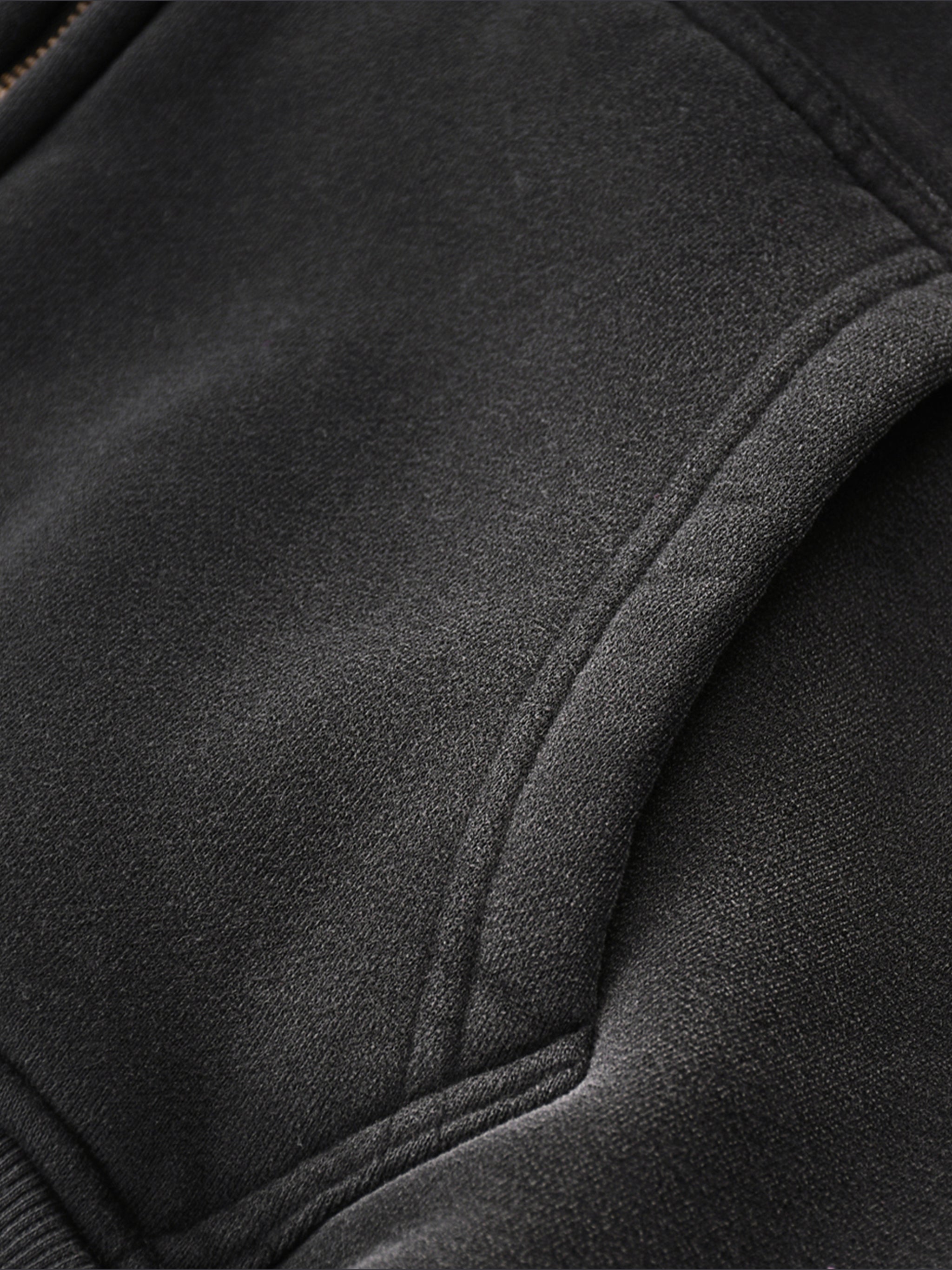 Close-up of a black jacket with a focus on texture and stitching detail.