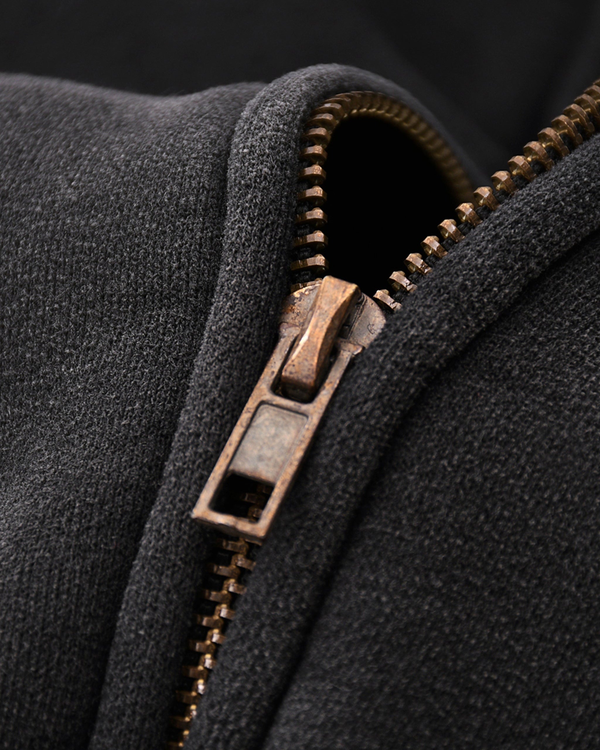 Close-up of a zip on a dark fabric background