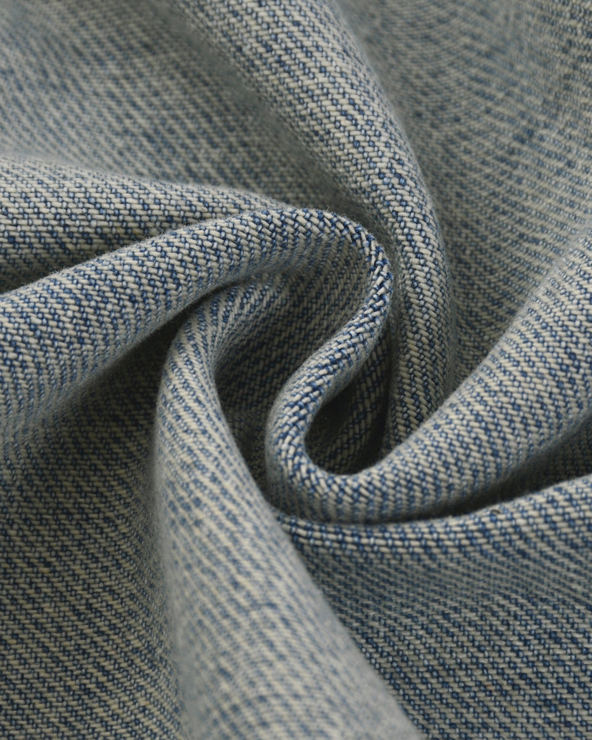 Close-up of textured blue fabric with a subtle pattern