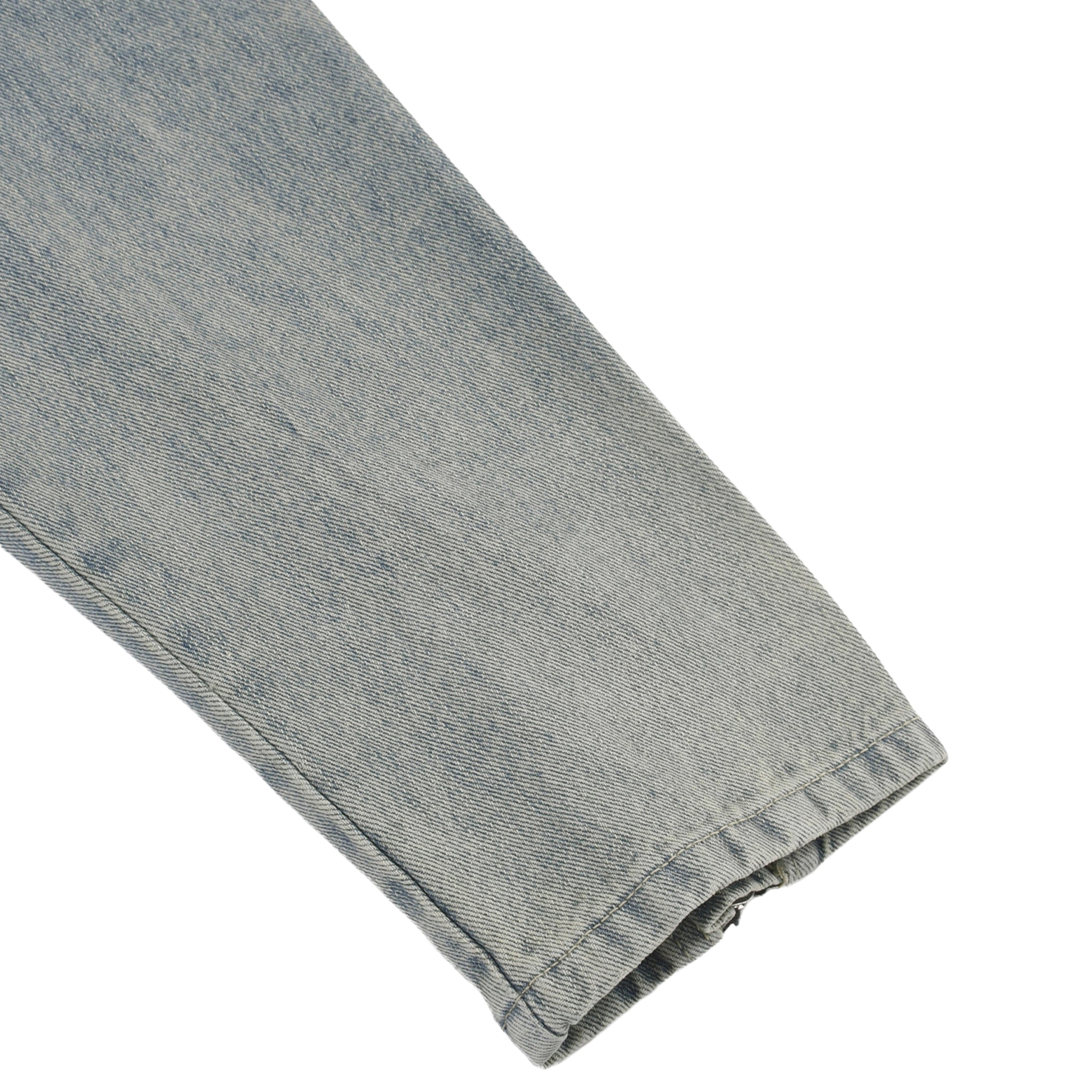 Close-up of a folded denim fabric on a white background