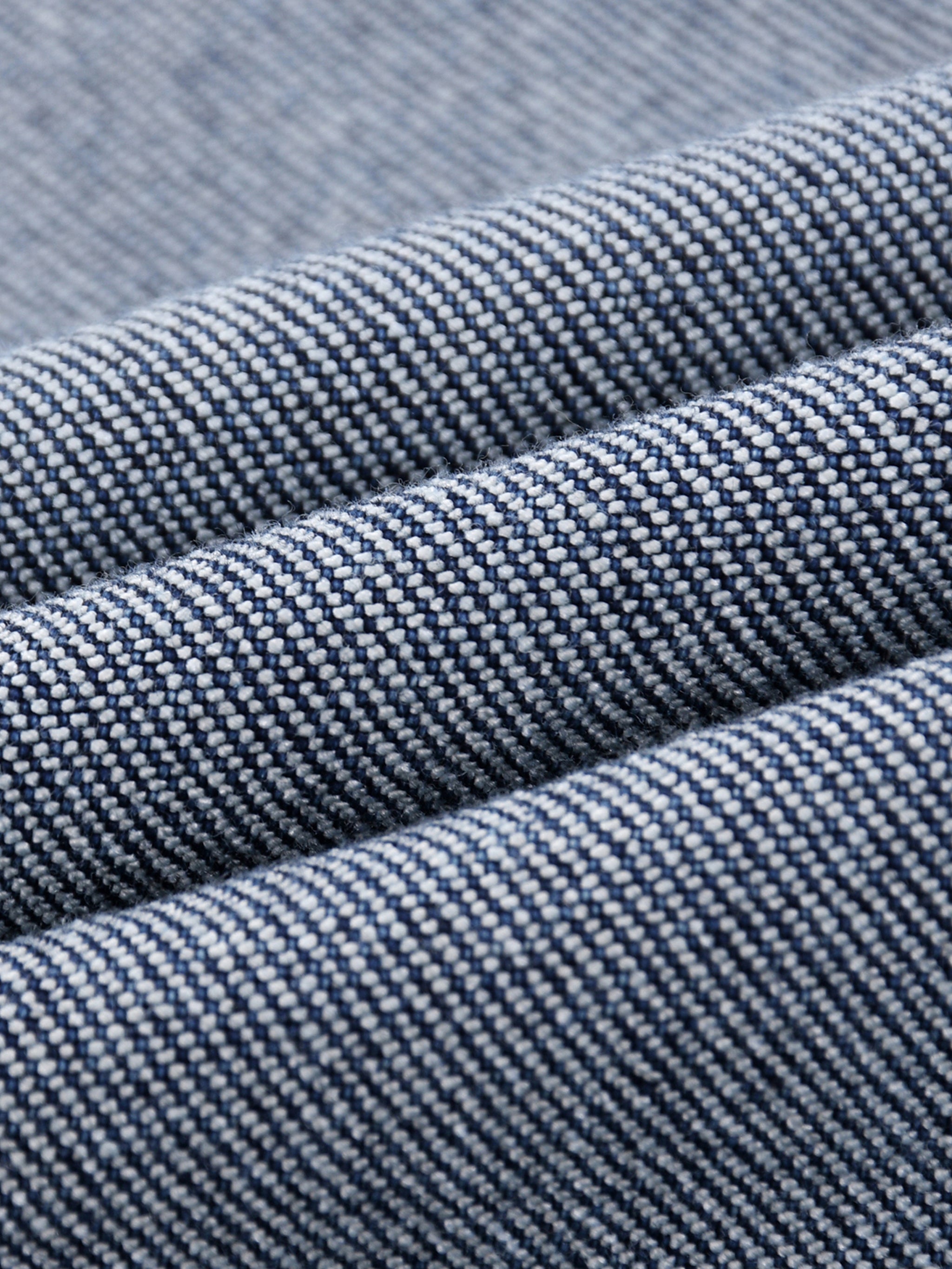 Close-up of blue denim fabric with a subtle pattern
