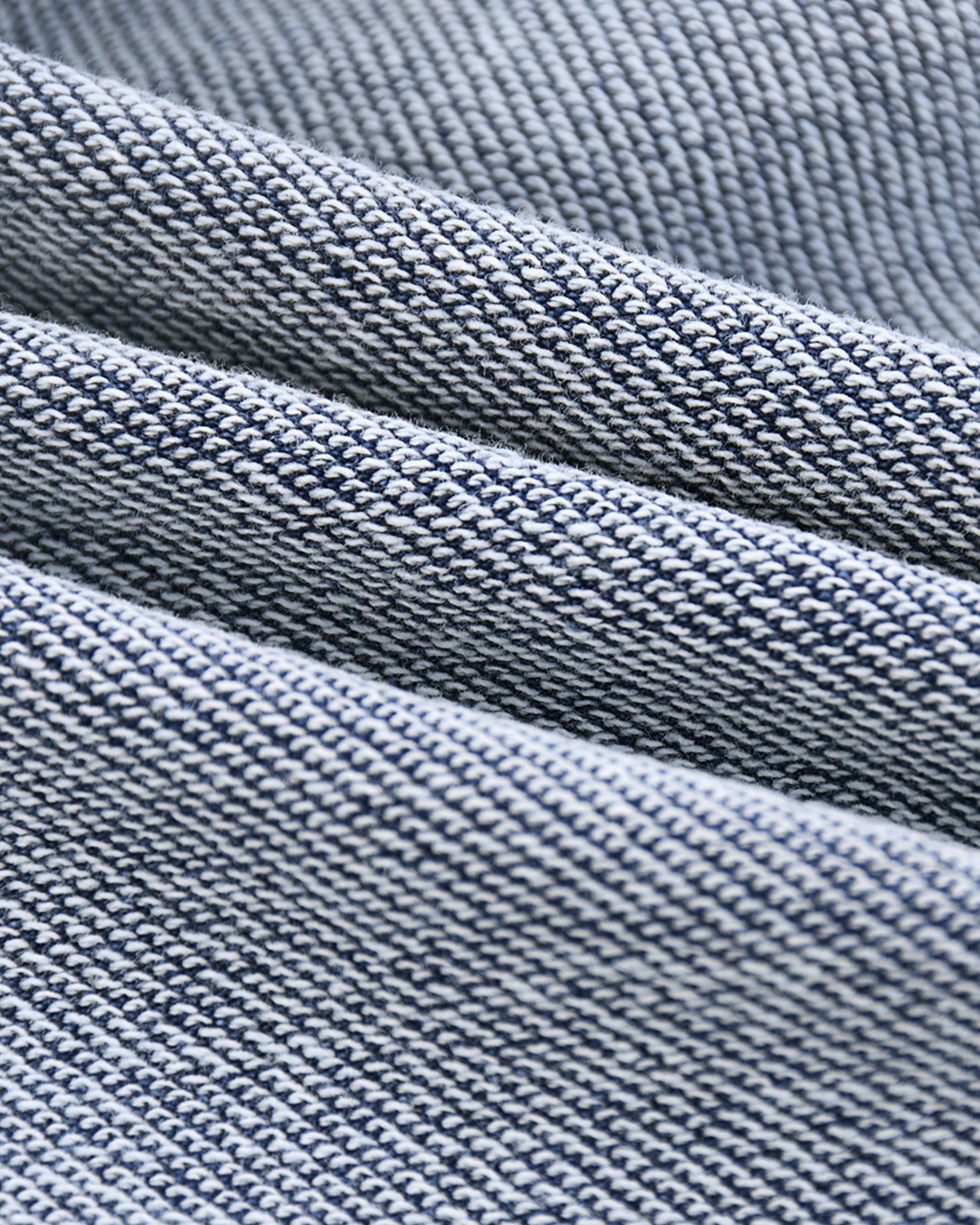 Close-up of blue denim fabric with a textured pattern