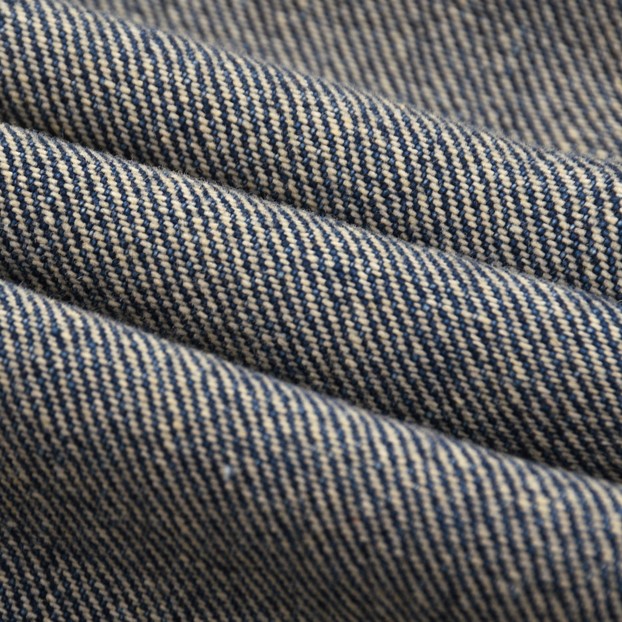 Close-up of blue denim fabric with visible stitching