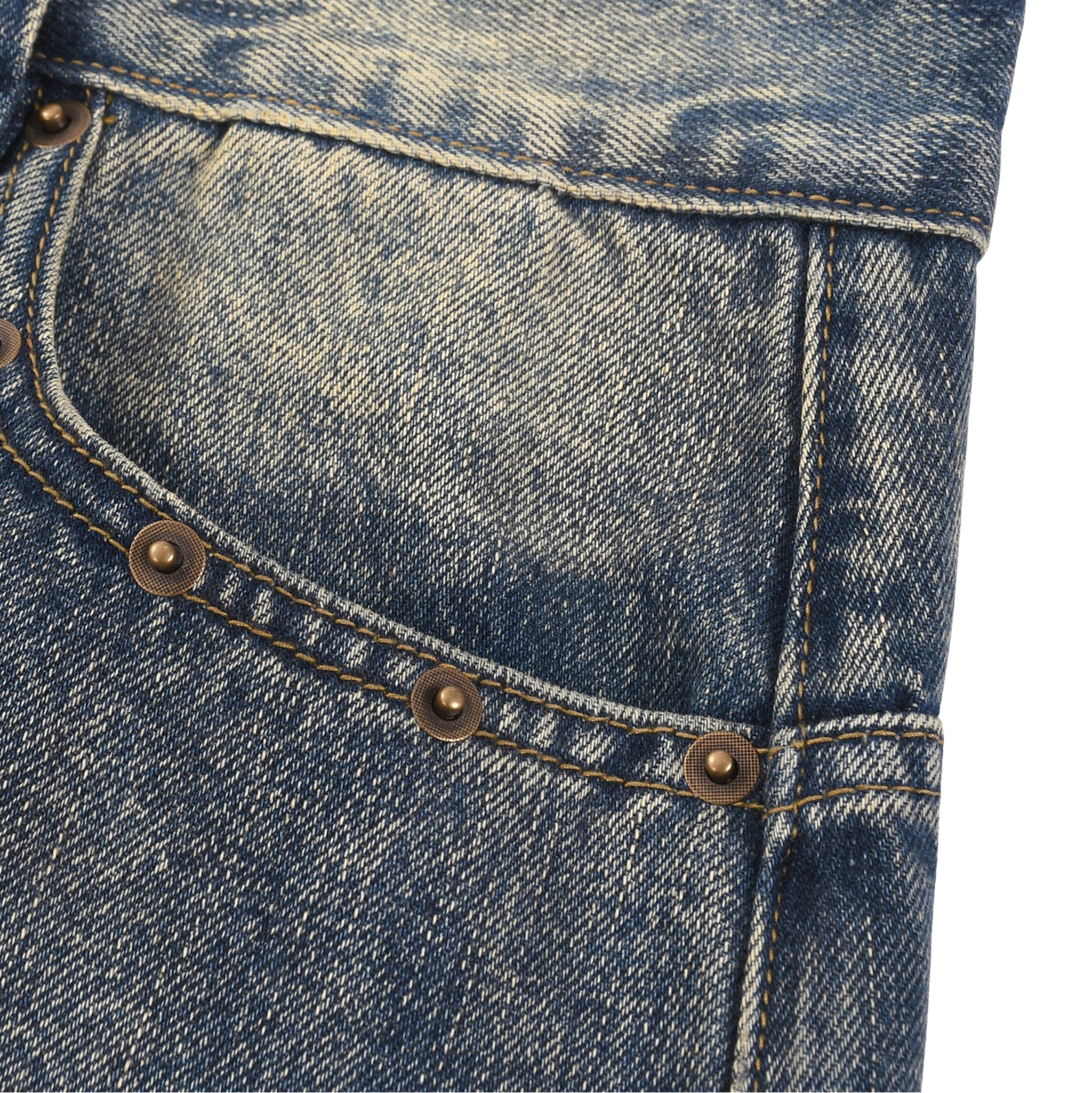Close-up of blue denim jeans with stitching and buttons on a white background