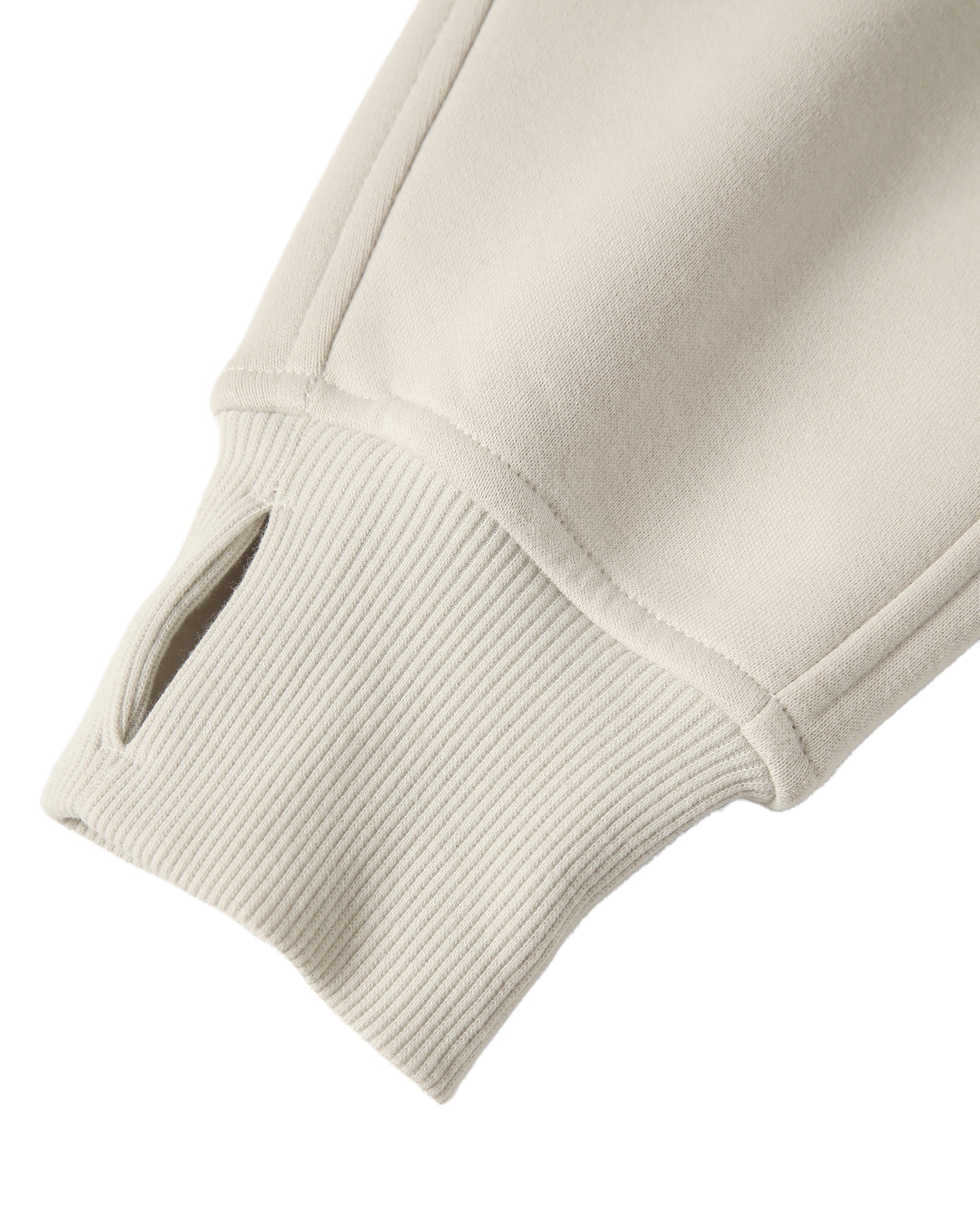 Close-up of a beige sweater sleeve on a white background