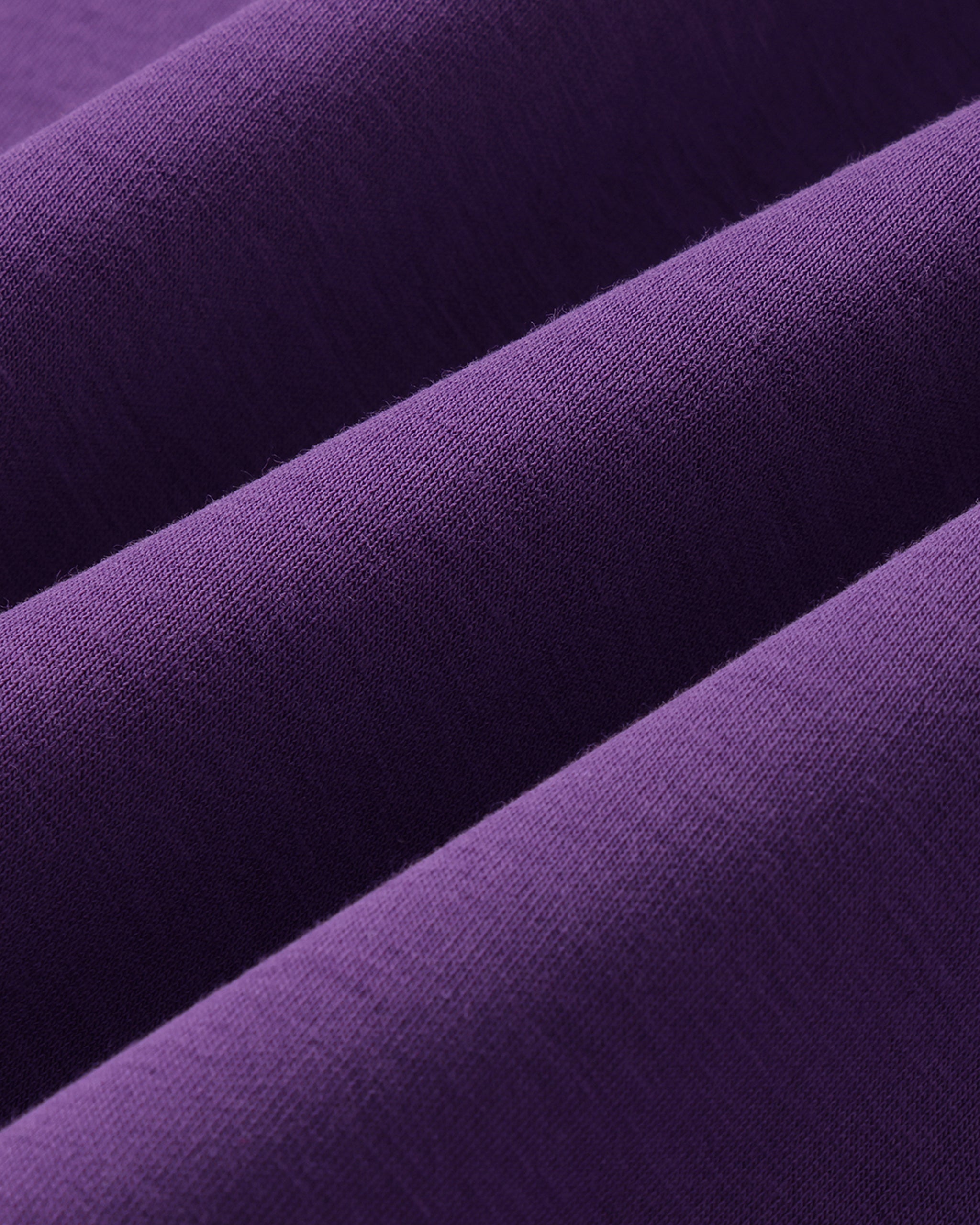 Close-up of purple fabric with a subtle texture