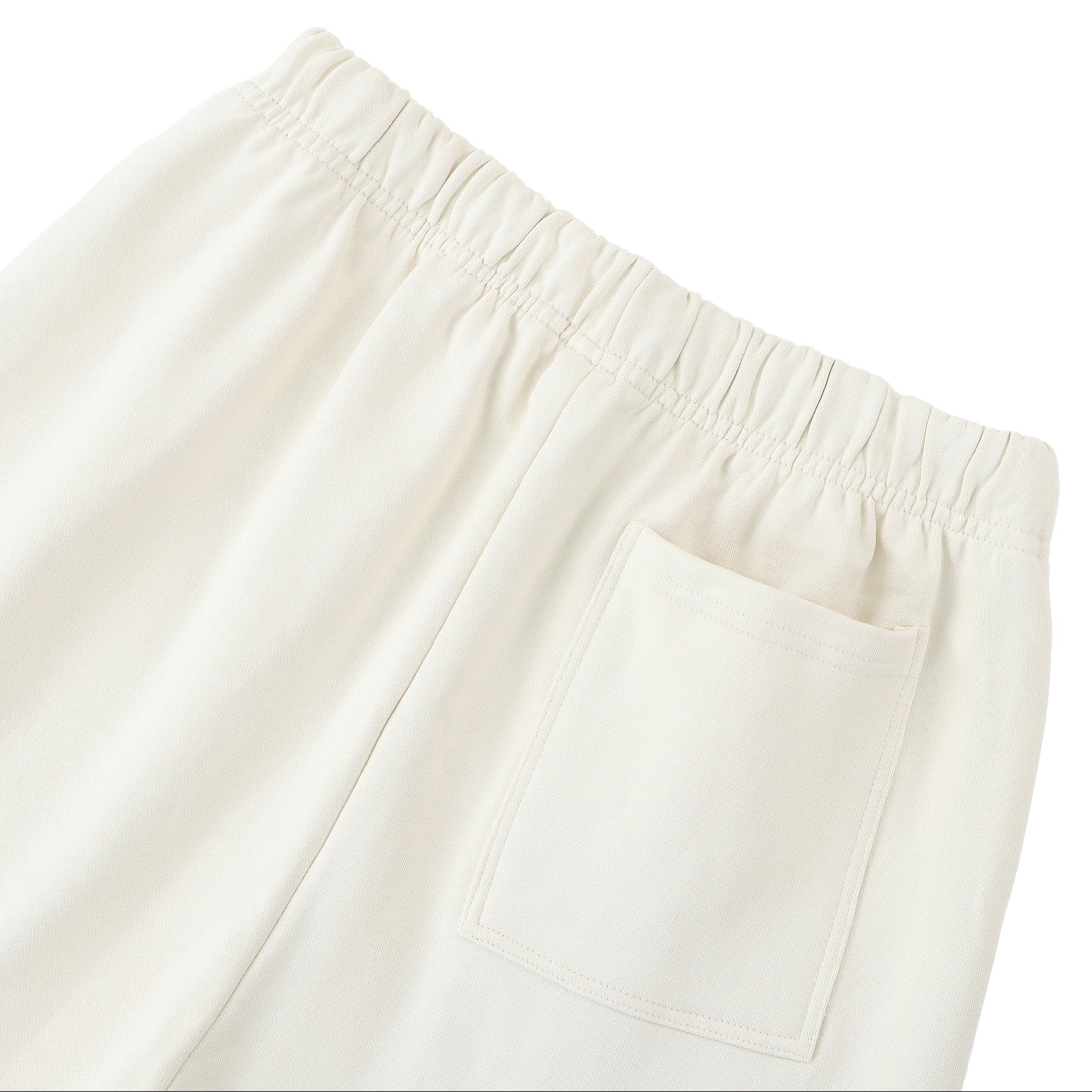 Close-up of beige pants with an elastic waistband on a white background
