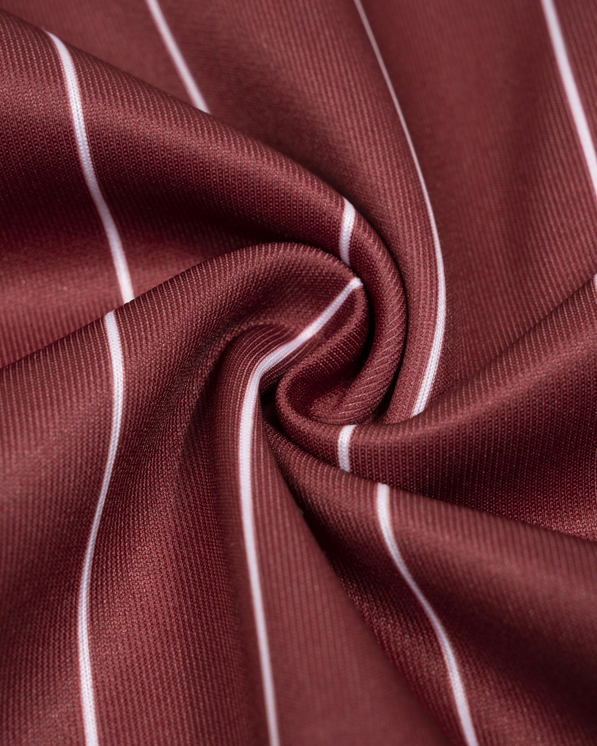 Close-up of maroon fabric with white stripes