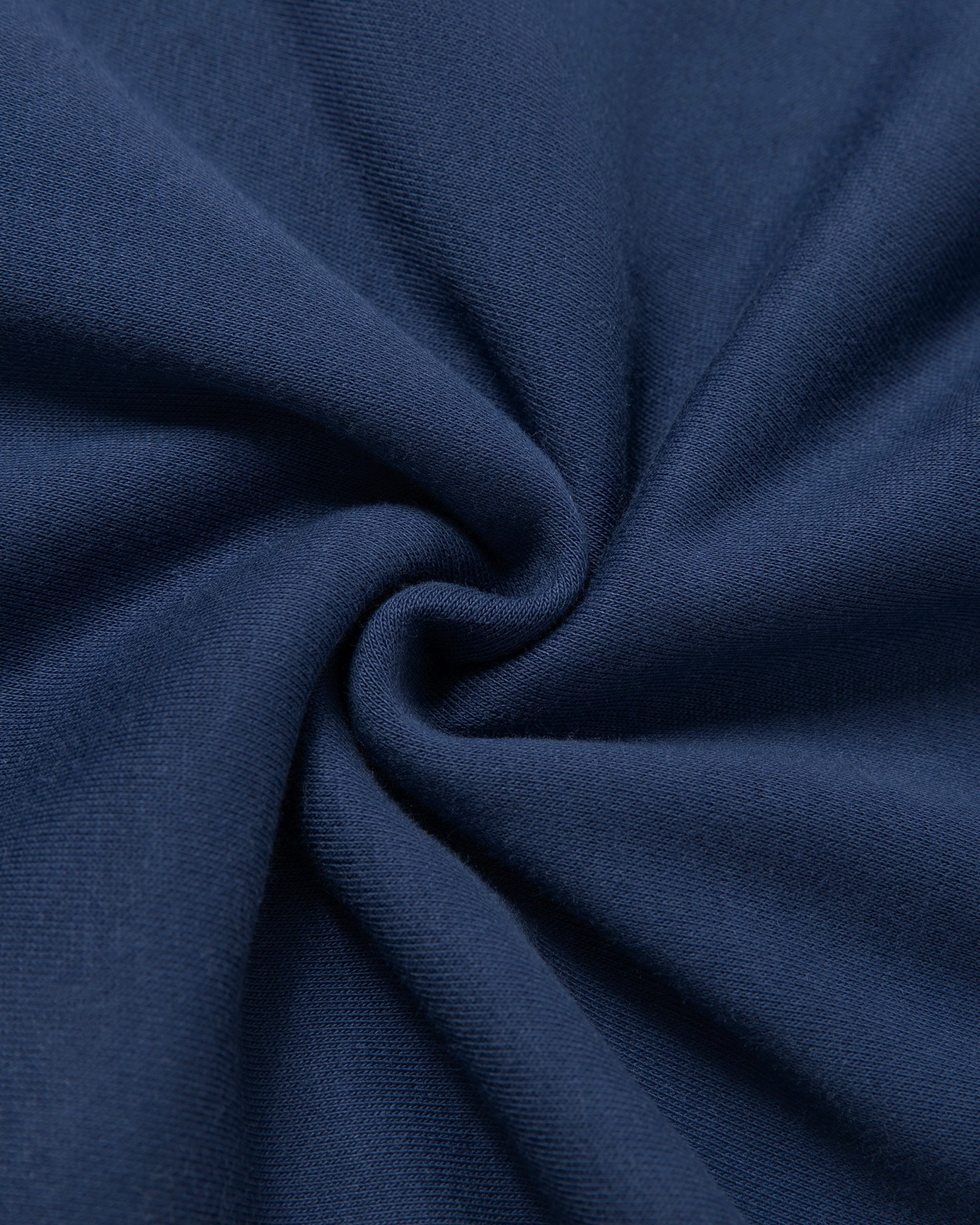 Close-up of dark blue fabric with folds