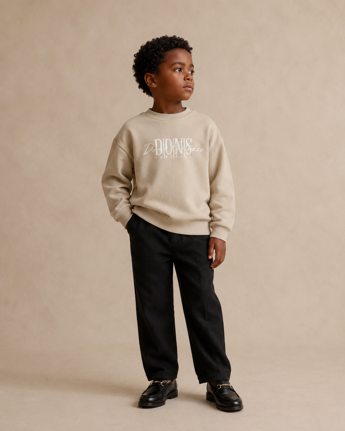 Child wearing a beige sweater with text on a beige background