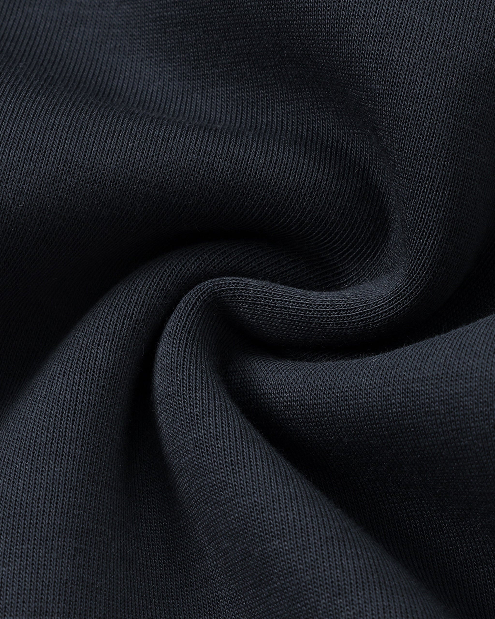 Close-up of dark blue fabric with a textured pattern