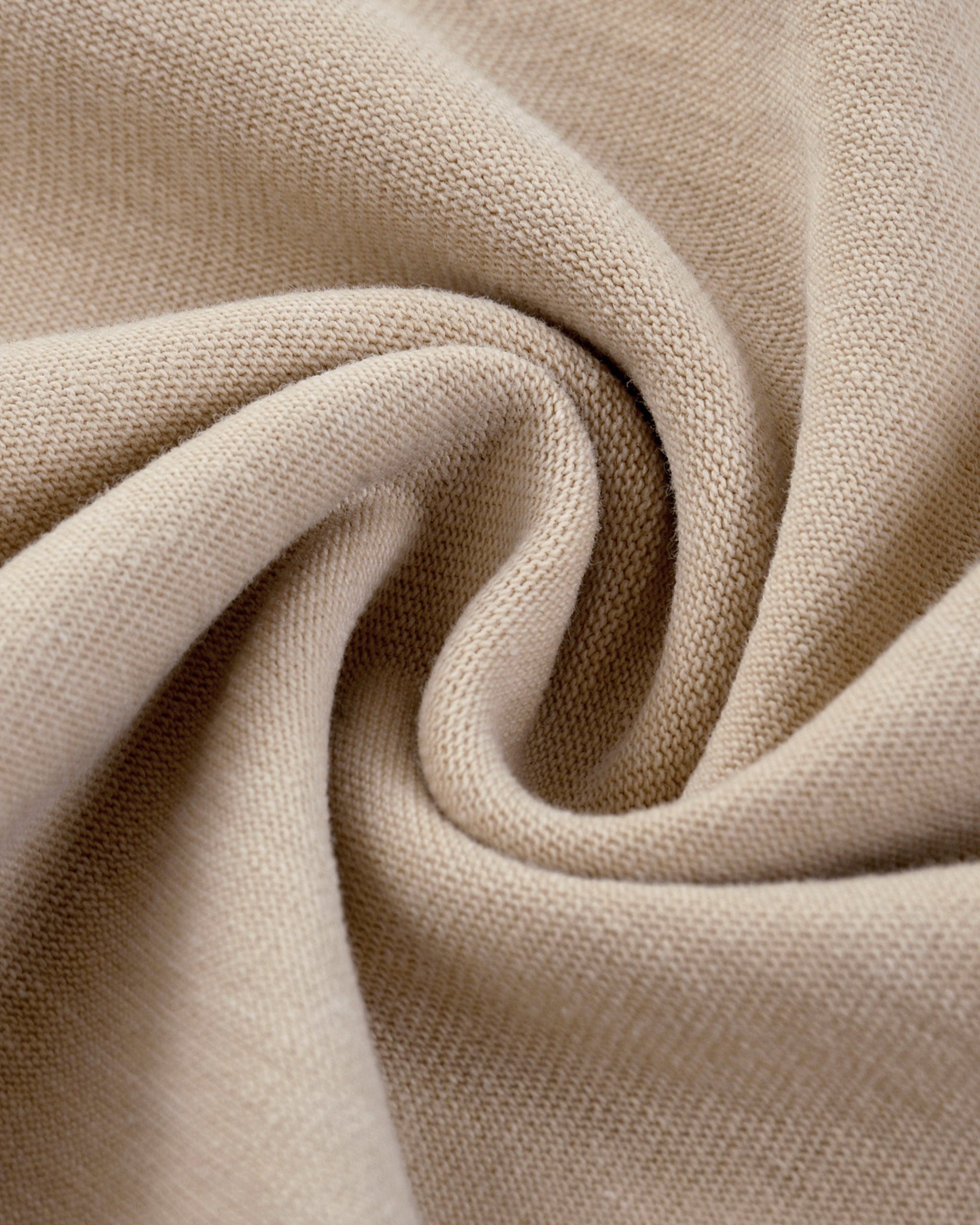 Close-up of beige fabric with a textured pattern