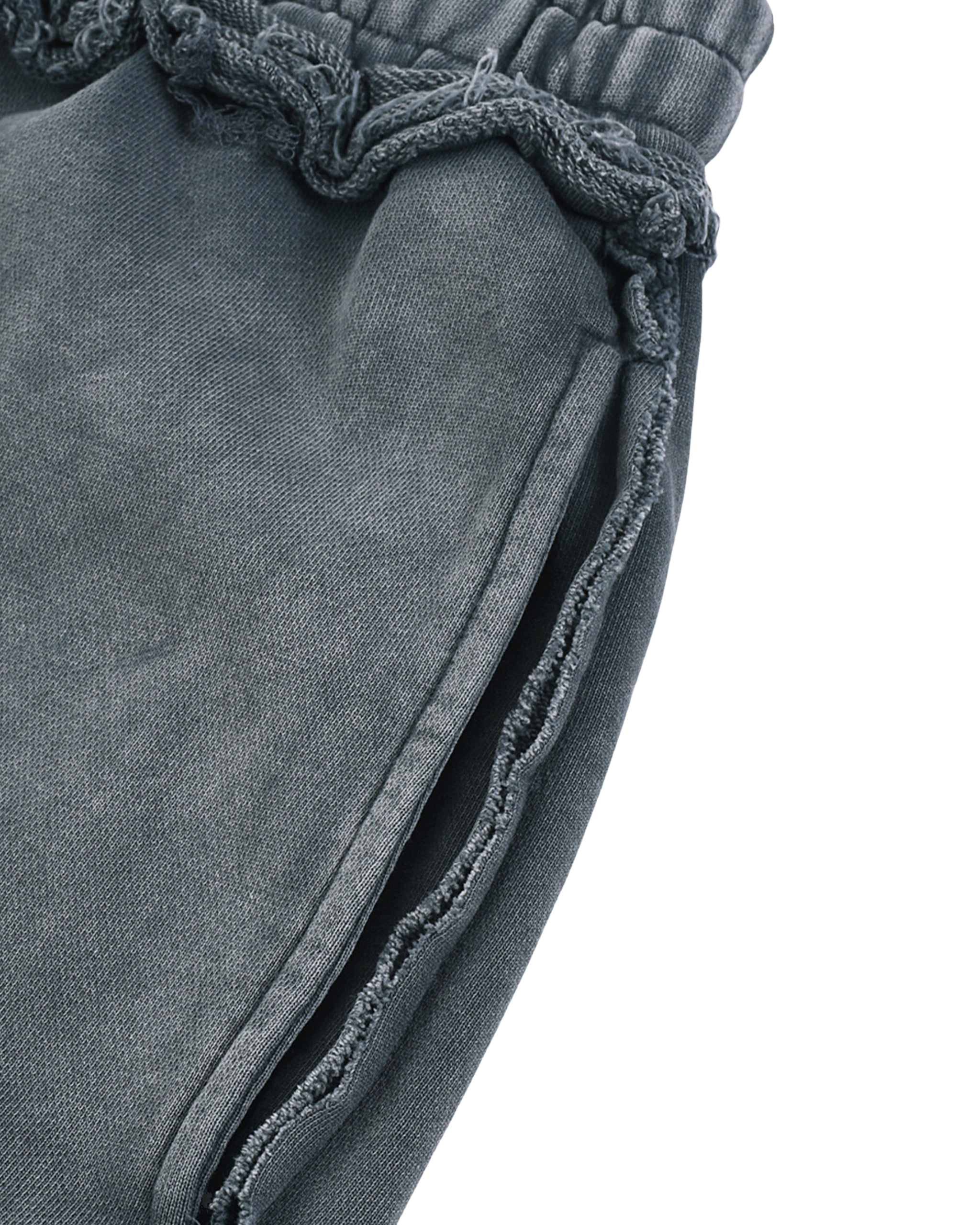 Close-up of gray pants with frayed edges on a white background