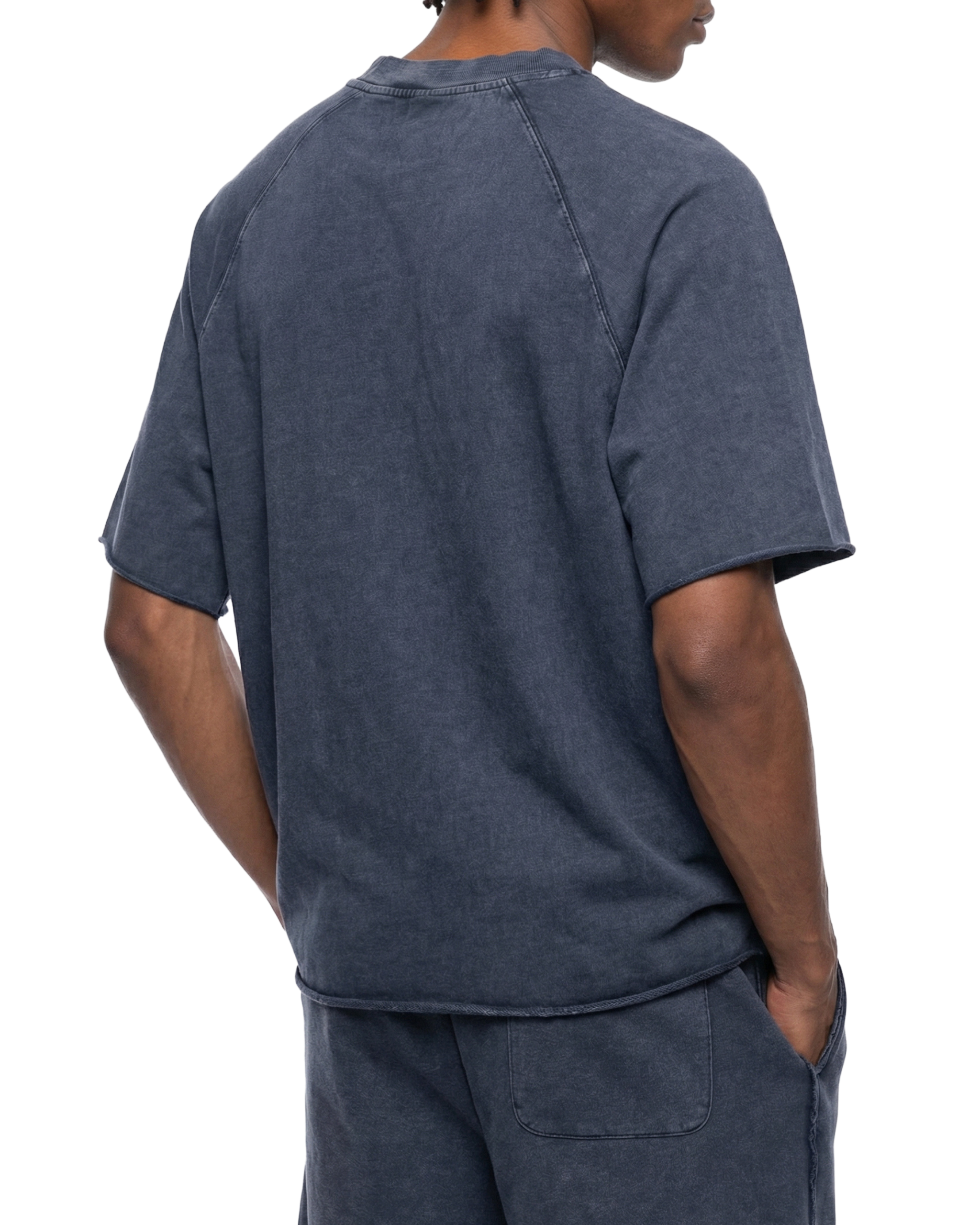 Person wearing a navy blue t-shirt and pants on a white background
