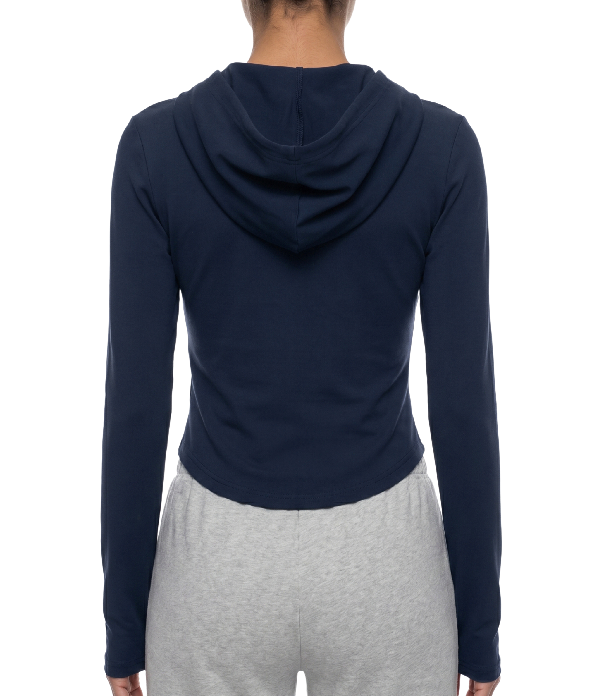 Person wearing a navy blue hoodie and gray pants on a white background