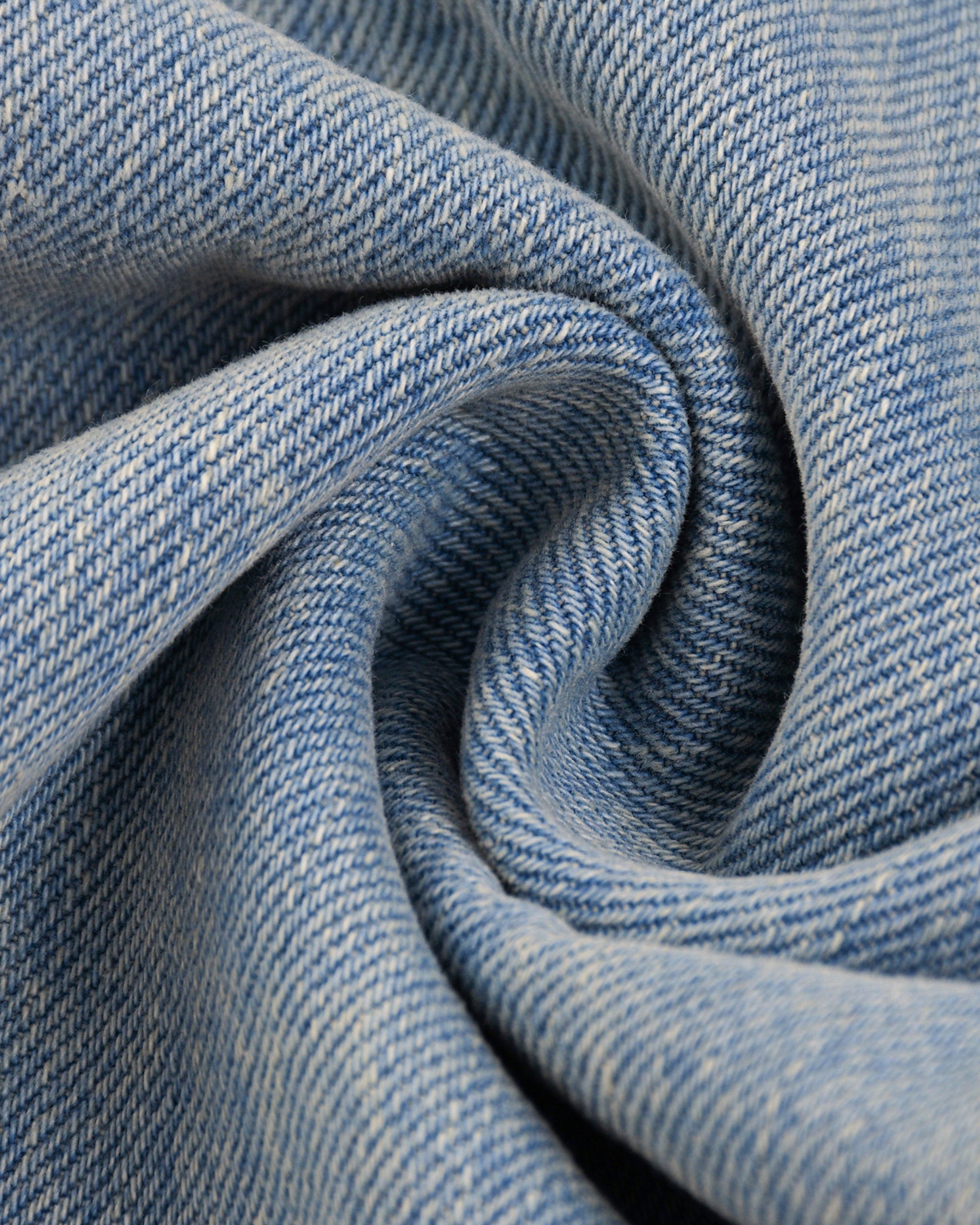Close-up of blue denim fabric with a swirl pattern