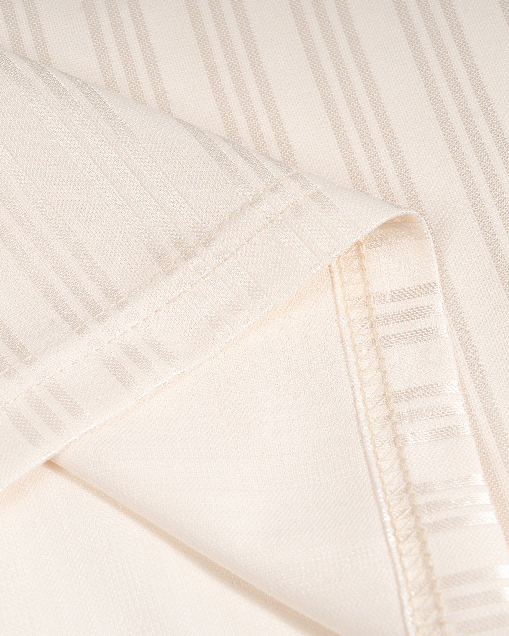 Close-up of a textured white fabric with a subtle pattern