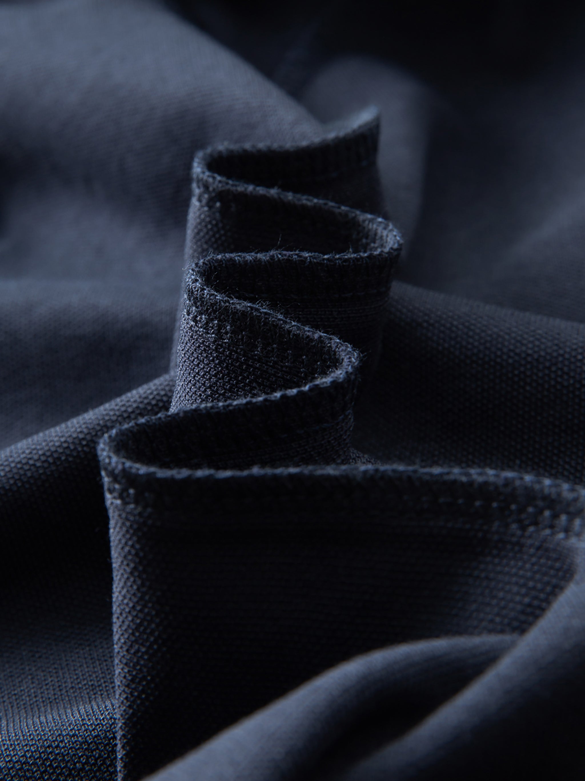 Close-up of dark blue fabric with a textured pattern