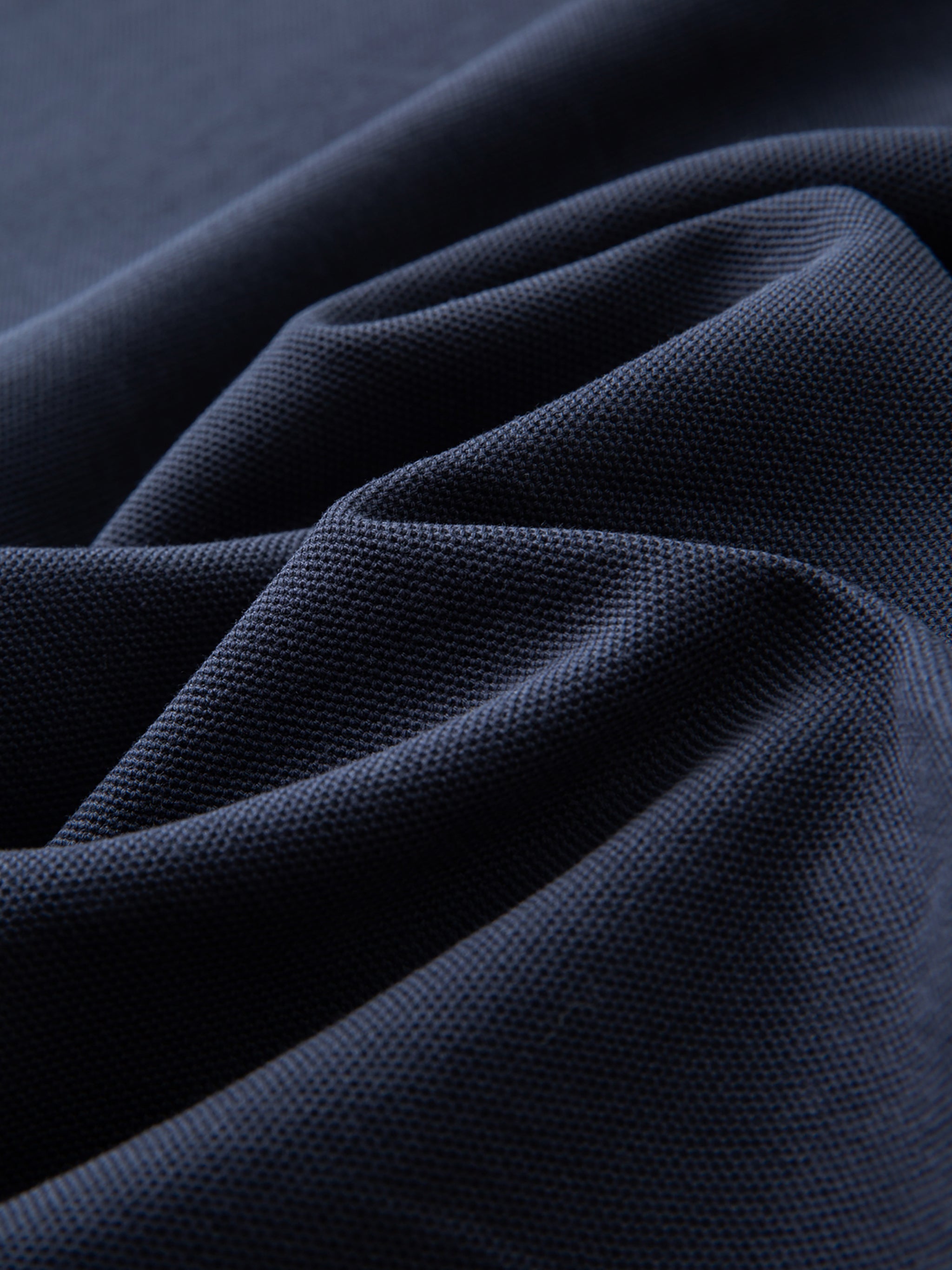 Close-up of dark blue fabric with a textured pattern