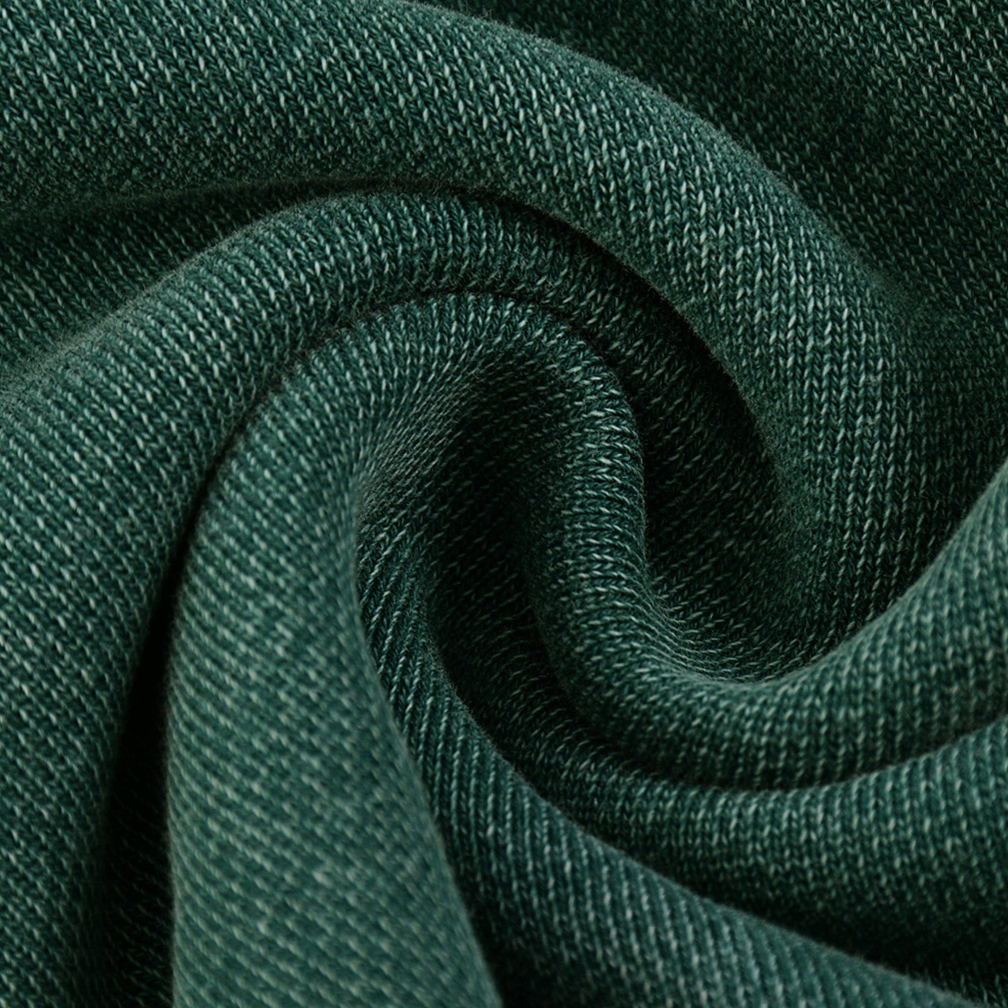 Close-up of dark green fabric with a textured pattern