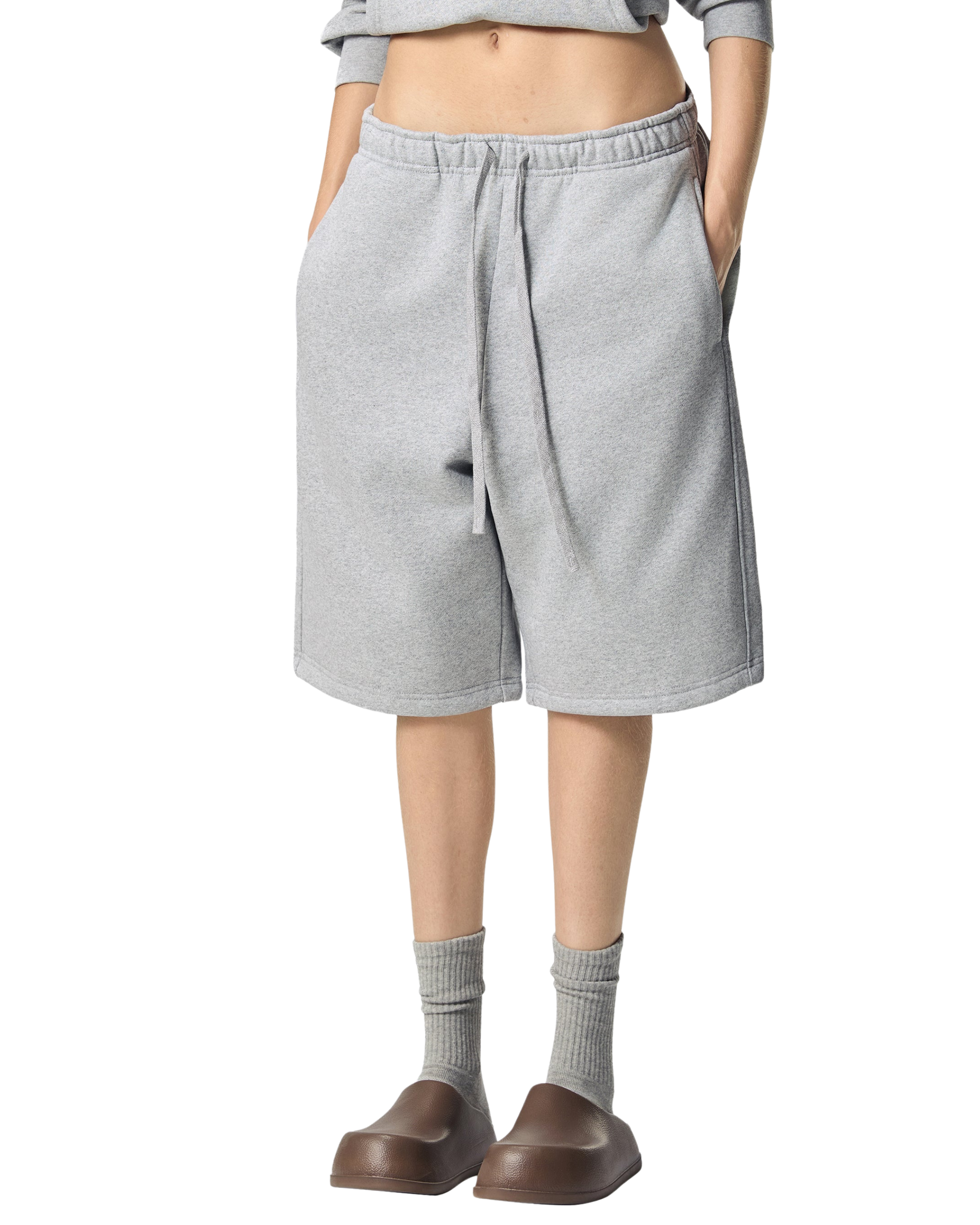 Person wearing gray shorts on a white background