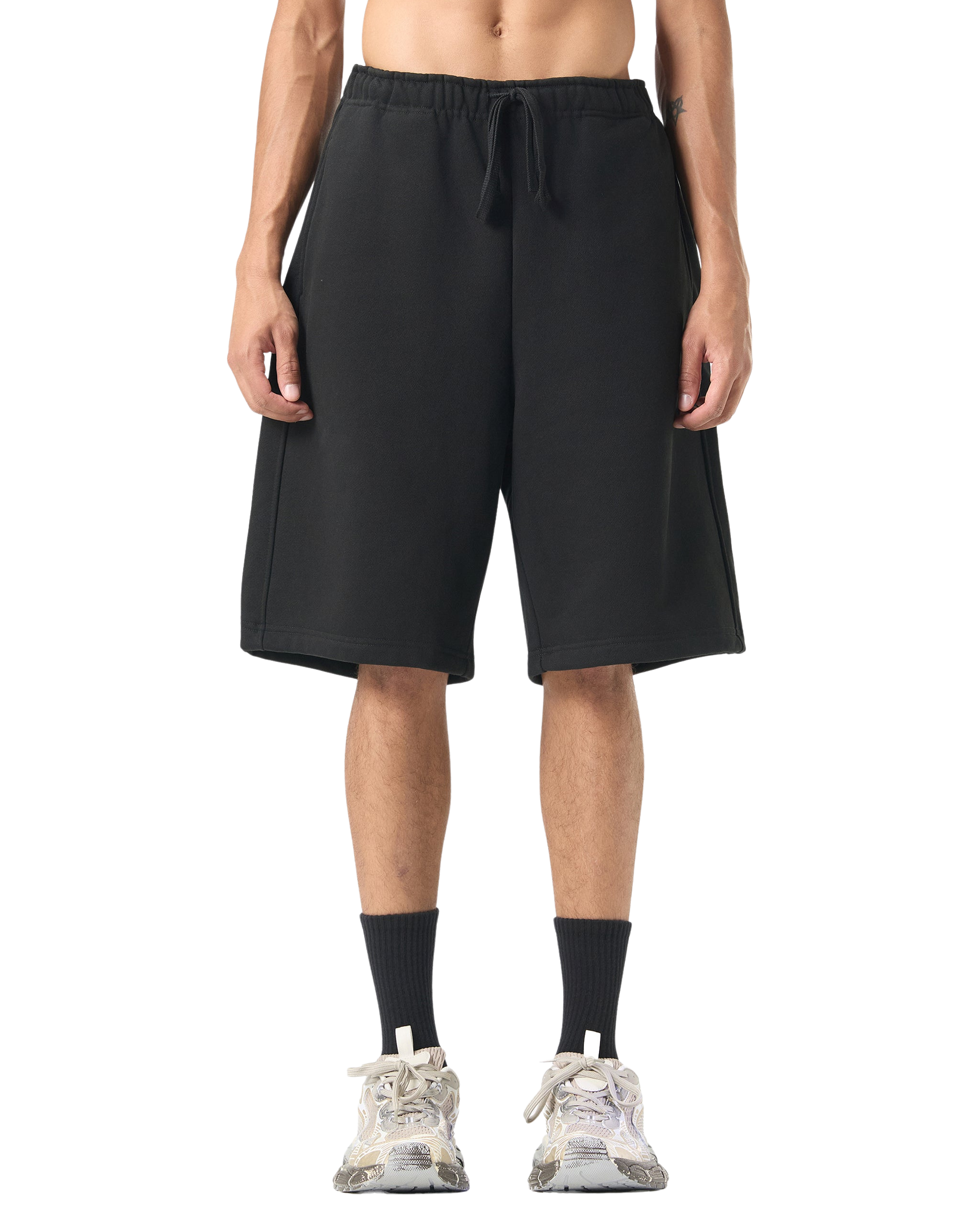 Person wearing black shorts on a white background
