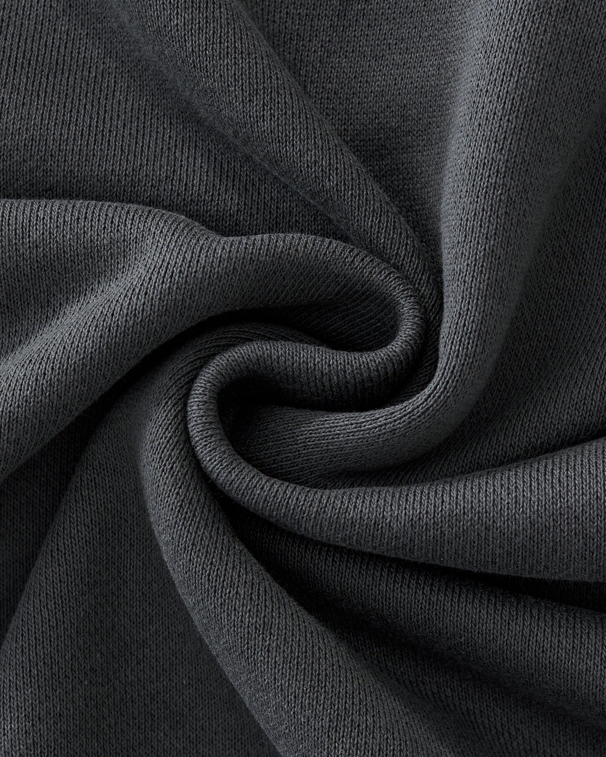 Close-up of dark gray fabric with folds