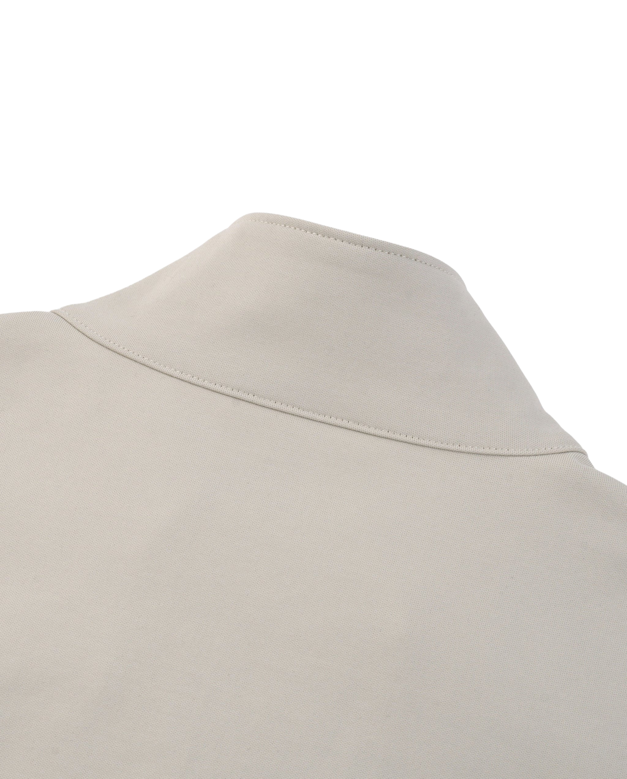 Close-up of a beige shirt collar on a white background