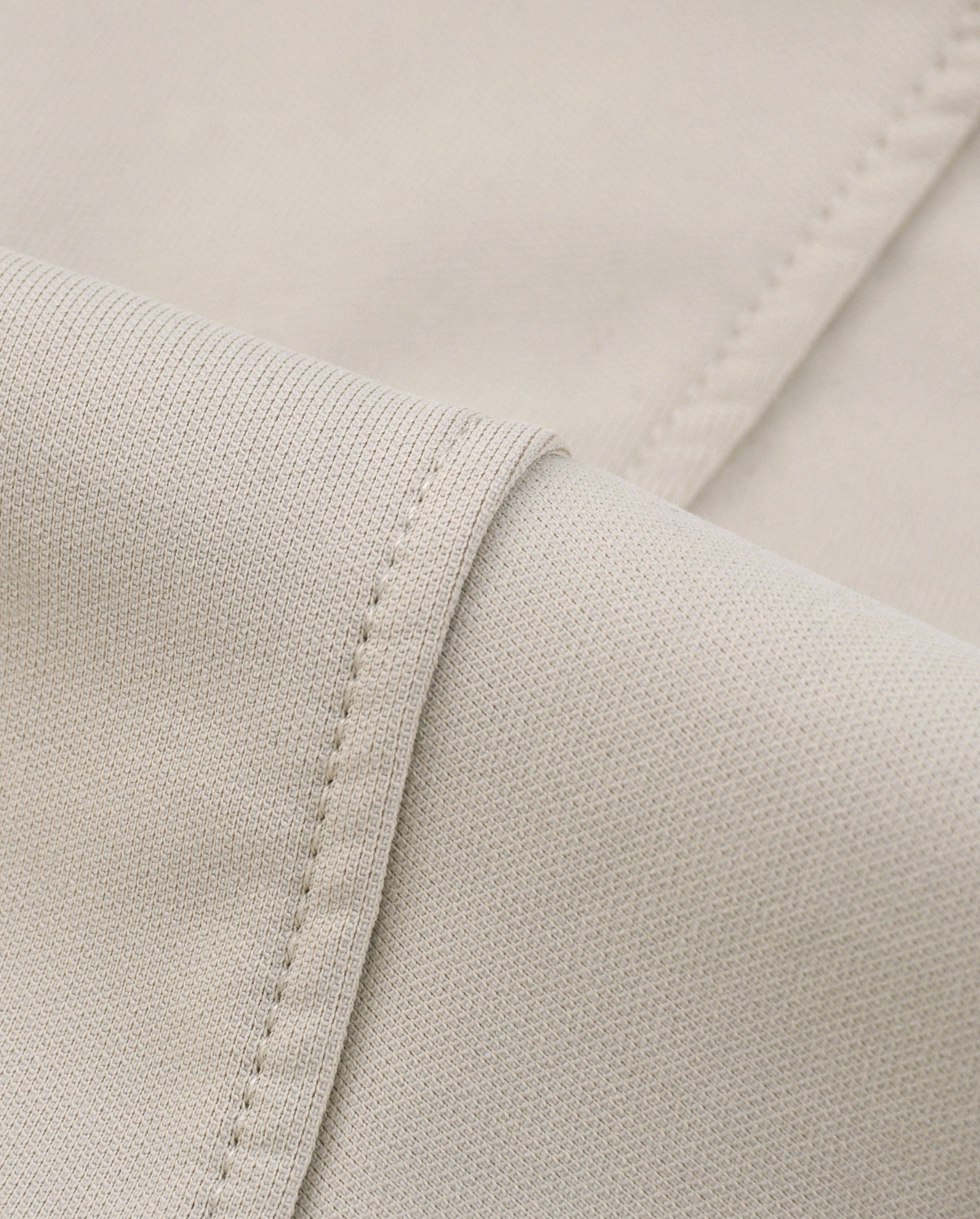 Close-up of beige fabric with stitching detail