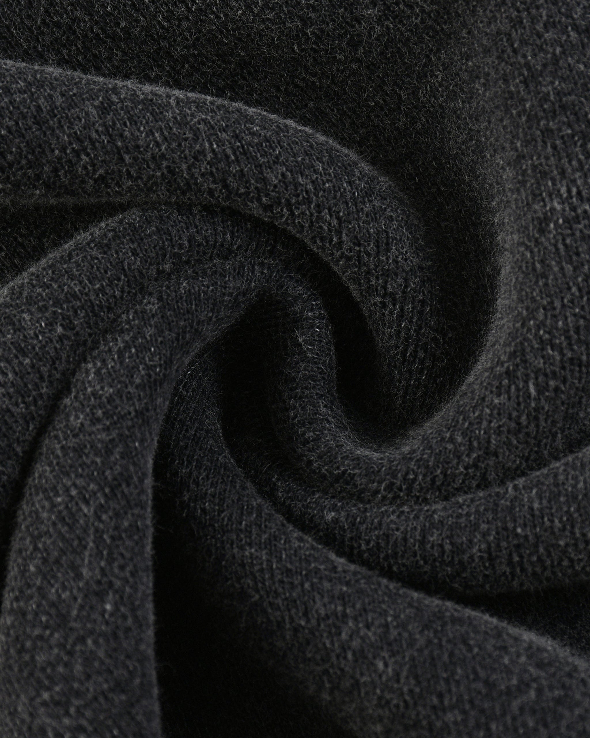 Close-up of dark gray fabric with a textured pattern