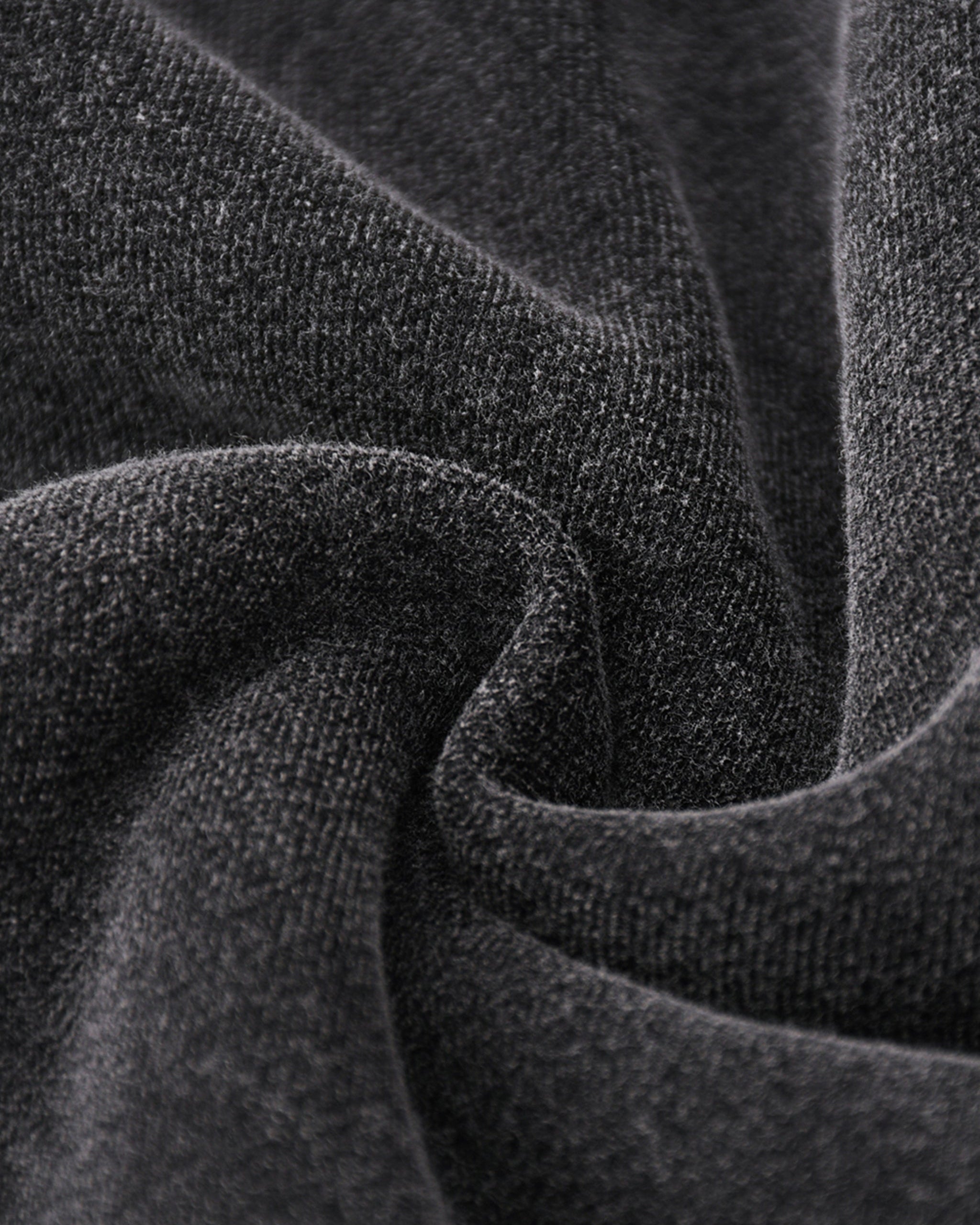 Close-up of dark gray fabric with a textured surface