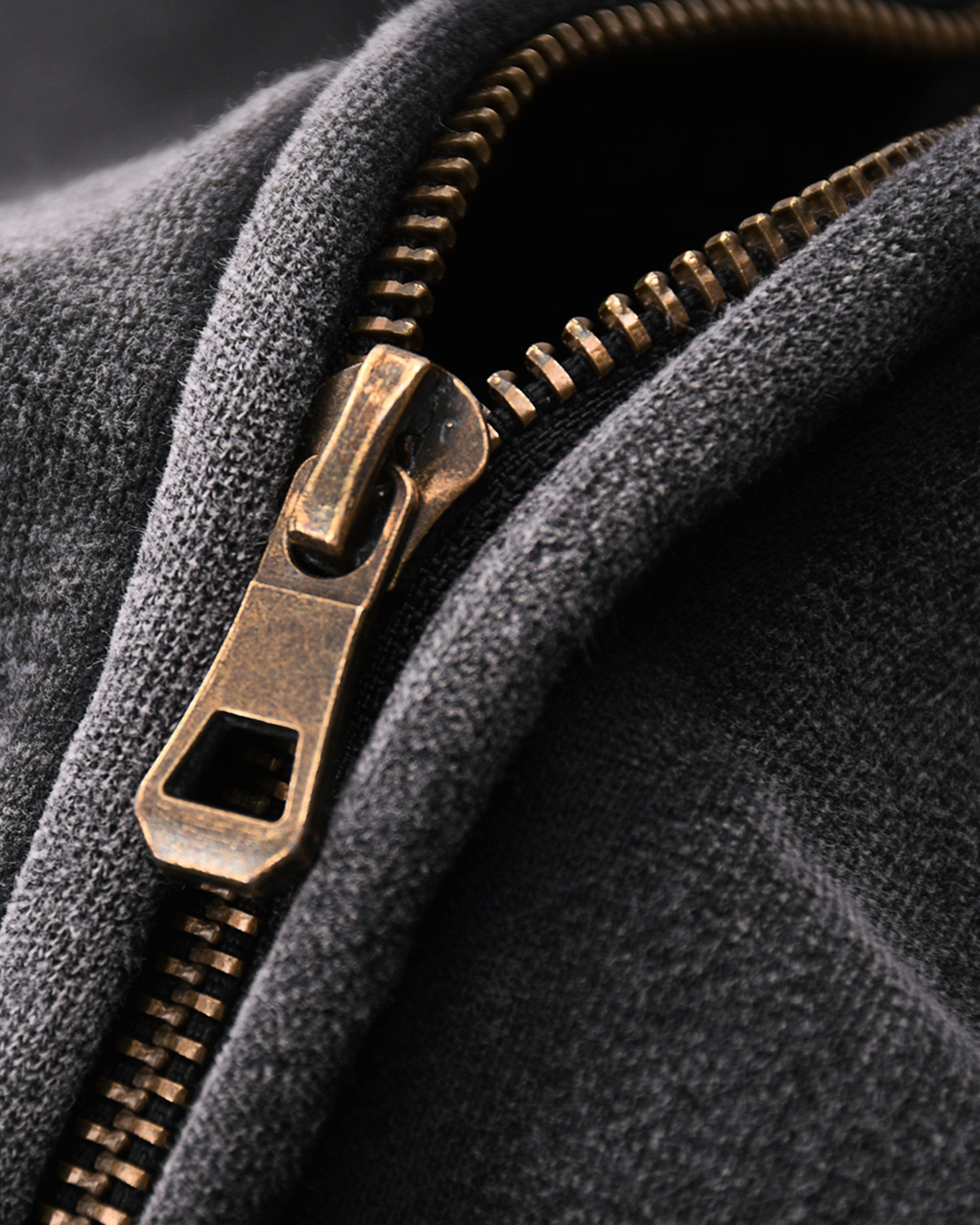 Close-up of a textured fabric with a brass zipper