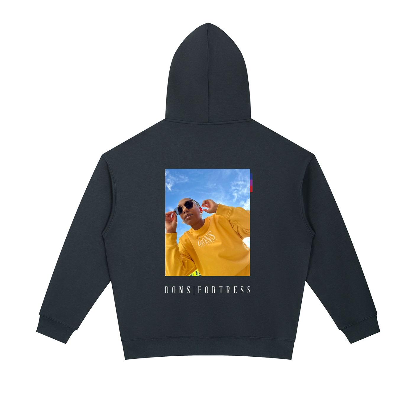 Navy hoodie with a printed design on the back featuring a person in a yellow outfit and 'Dons Fortress' text.