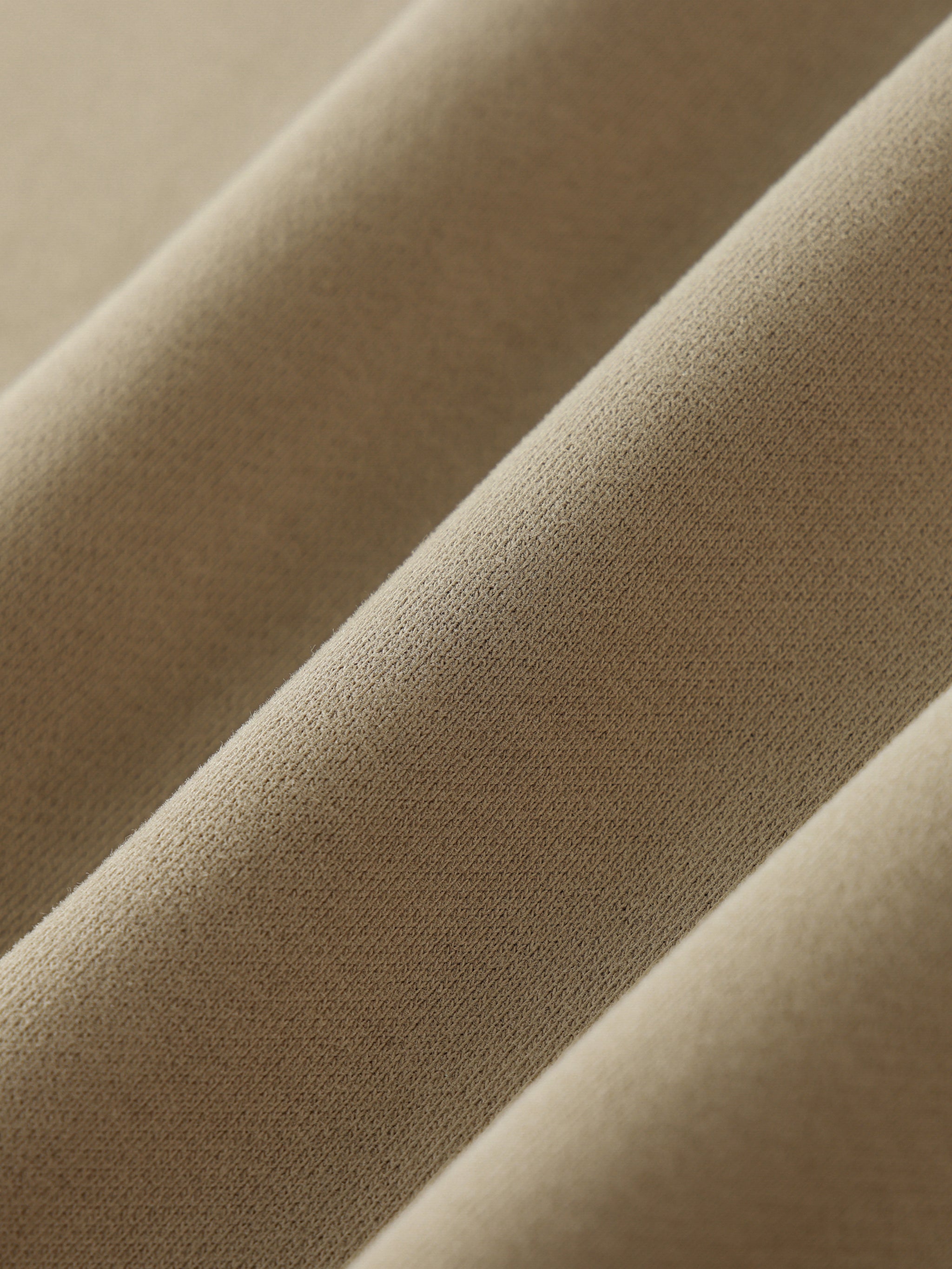 Close-up of beige fabric with a soft texture