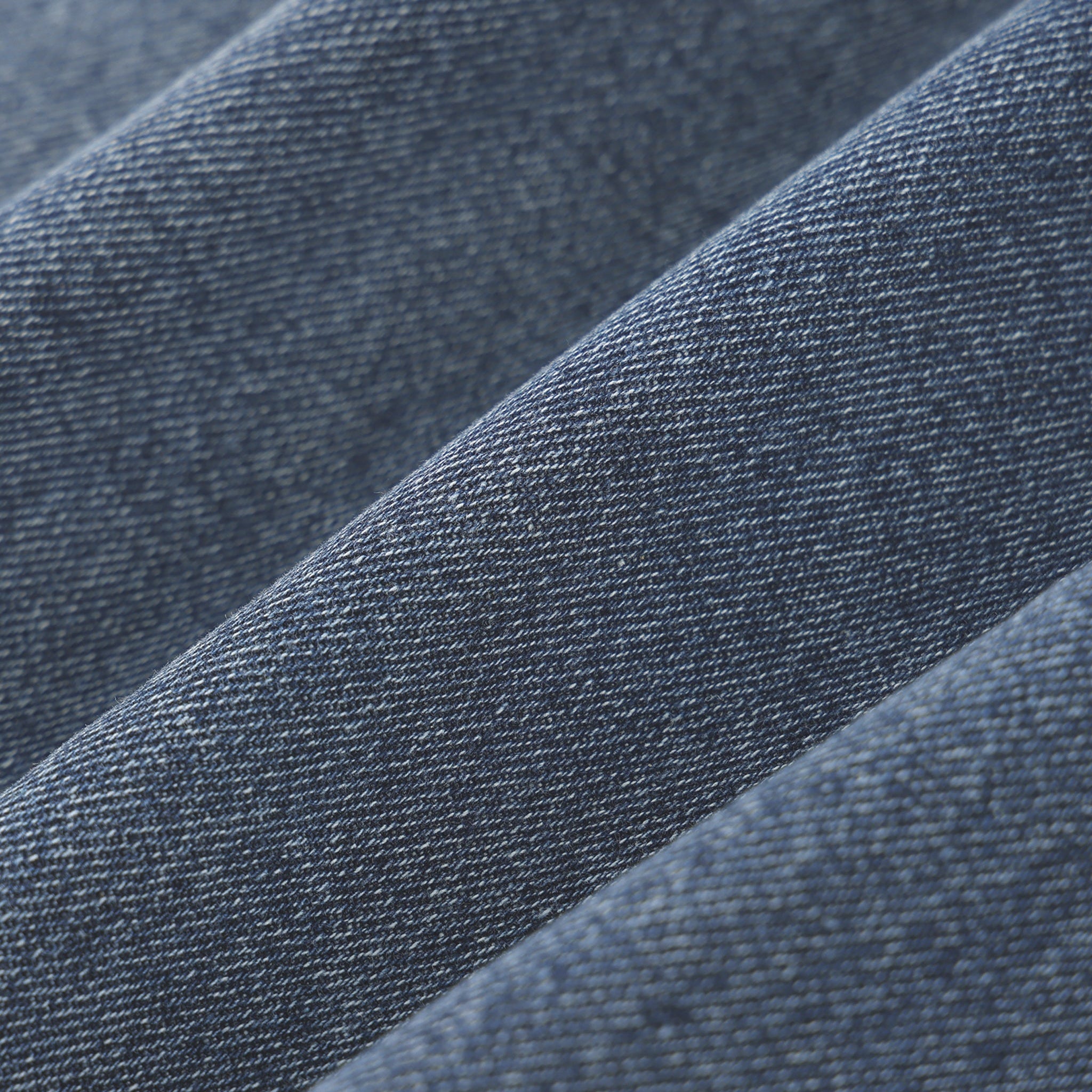 Close-up of blue denim fabric with a subtle pattern