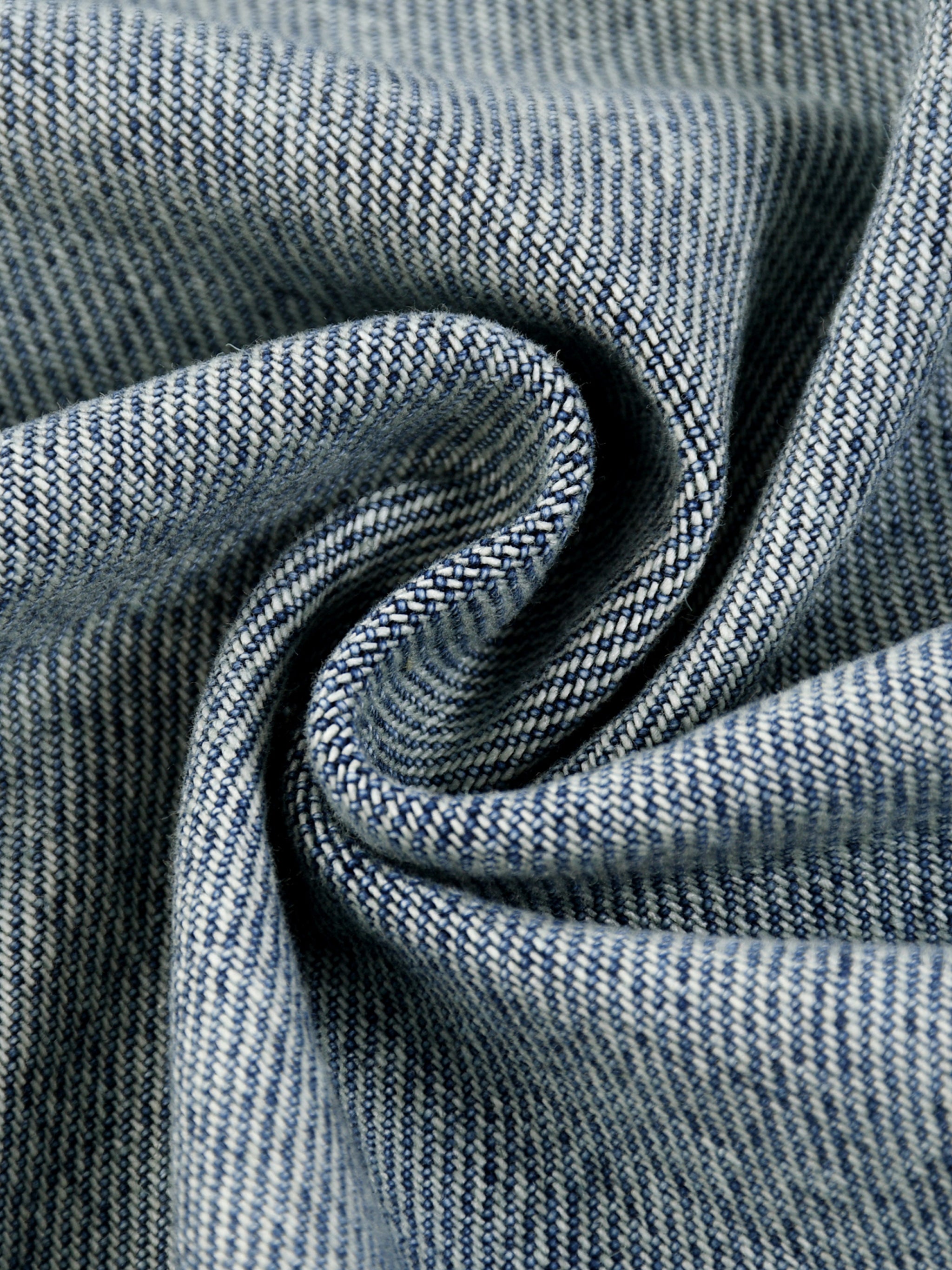 Close-up of blue denim fabric with a subtle pattern