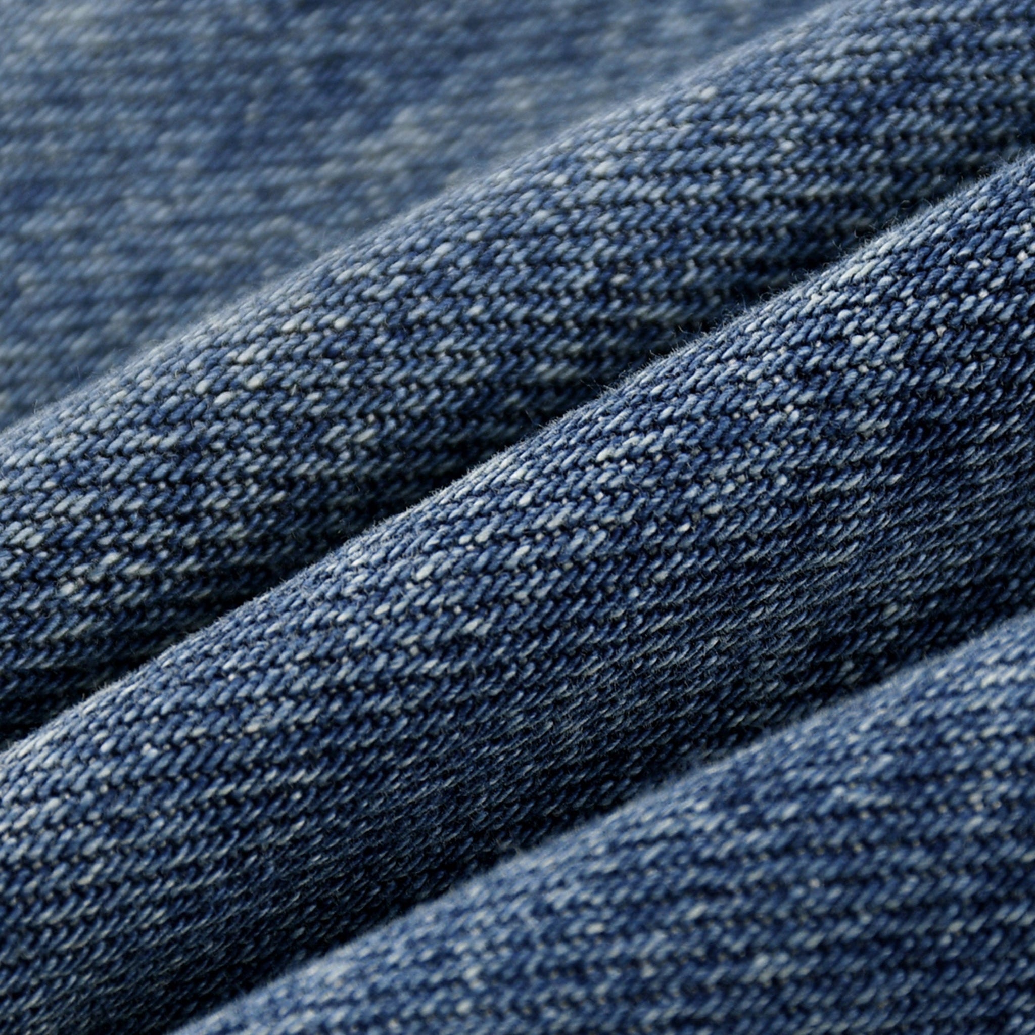 Close-up of blue denim fabric with a textured pattern