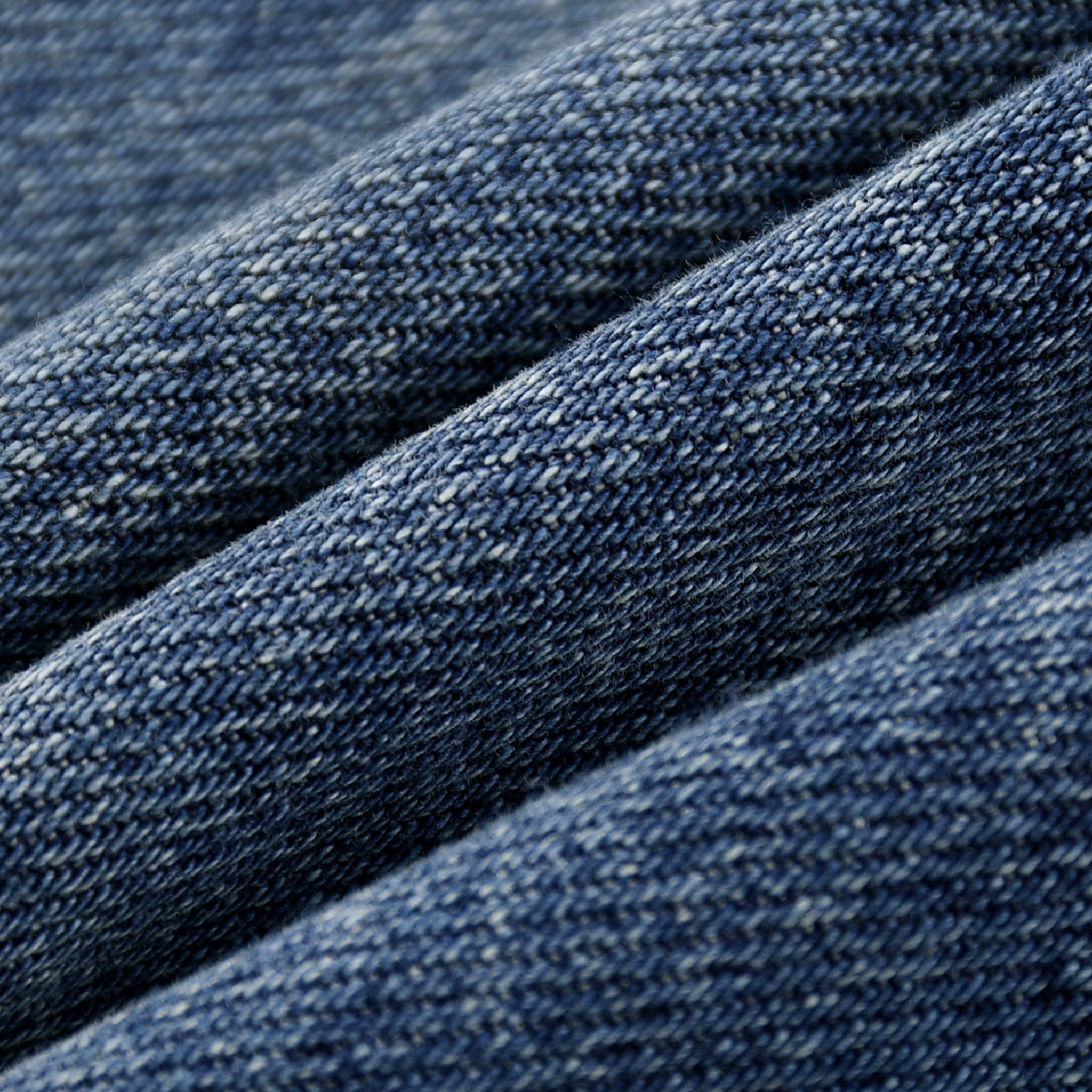 Close-up of blue denim fabric with a textured pattern