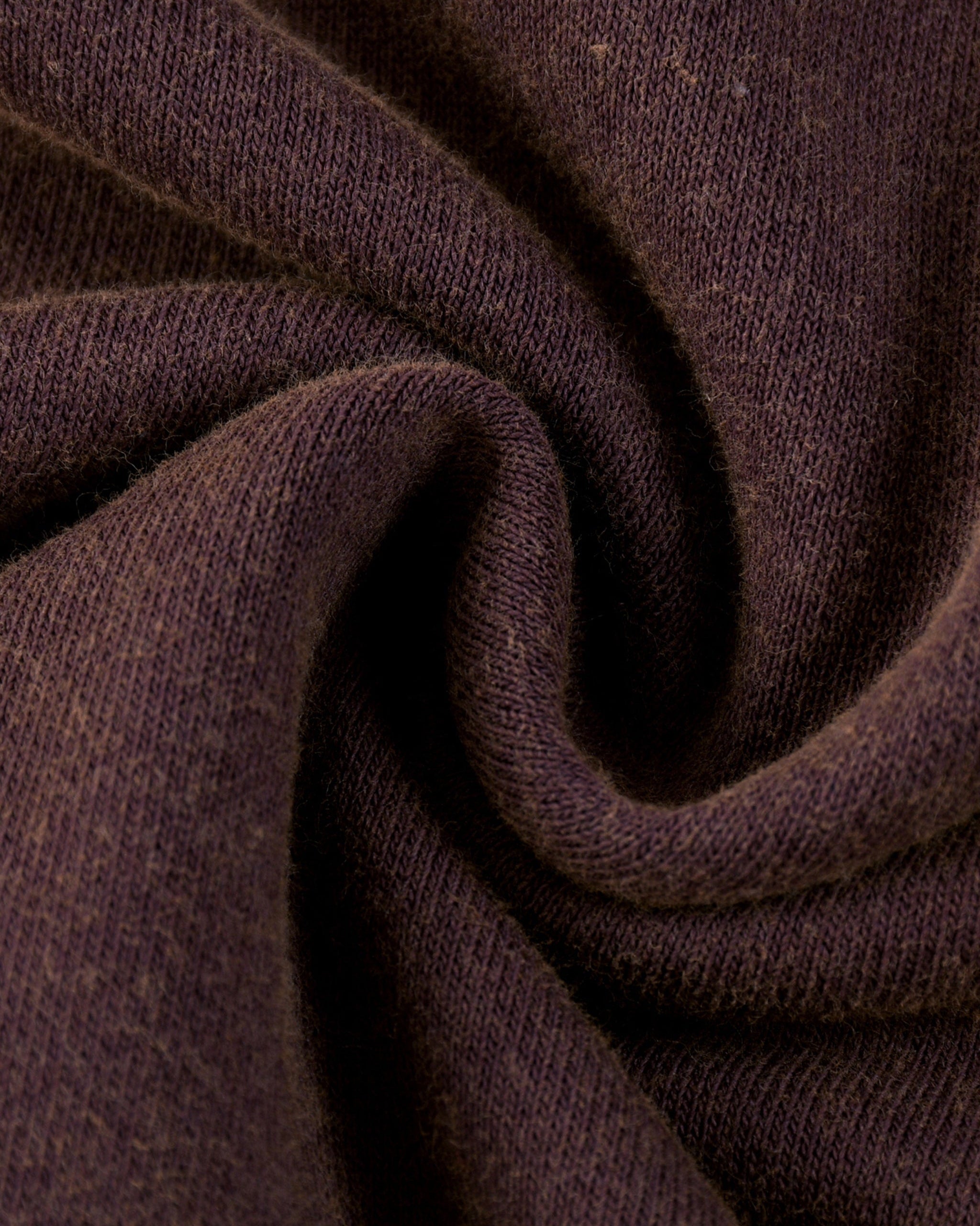 Close-up of dark brown fabric with visible texture