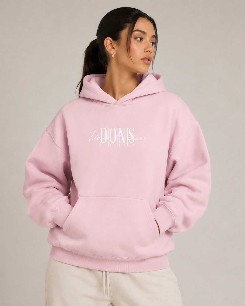 Person wearing a pink hoodie with text on a plain background