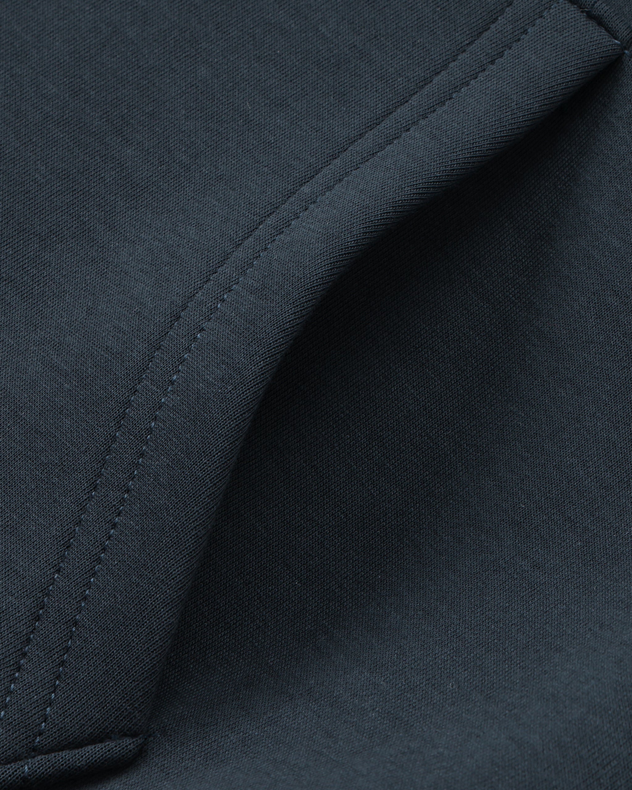 Close-up of a dark blue fabric with stitching detail